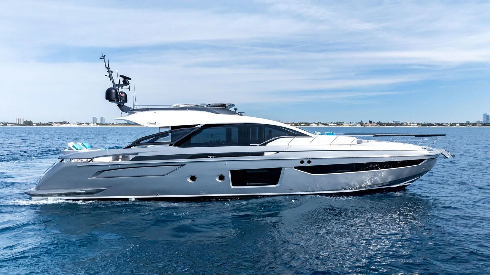 A sleek and modern yacht glides effortlessly on calm blue waters, showcasing its elegant design. aboard OCEAN'S SE7EN Yacht for Sale