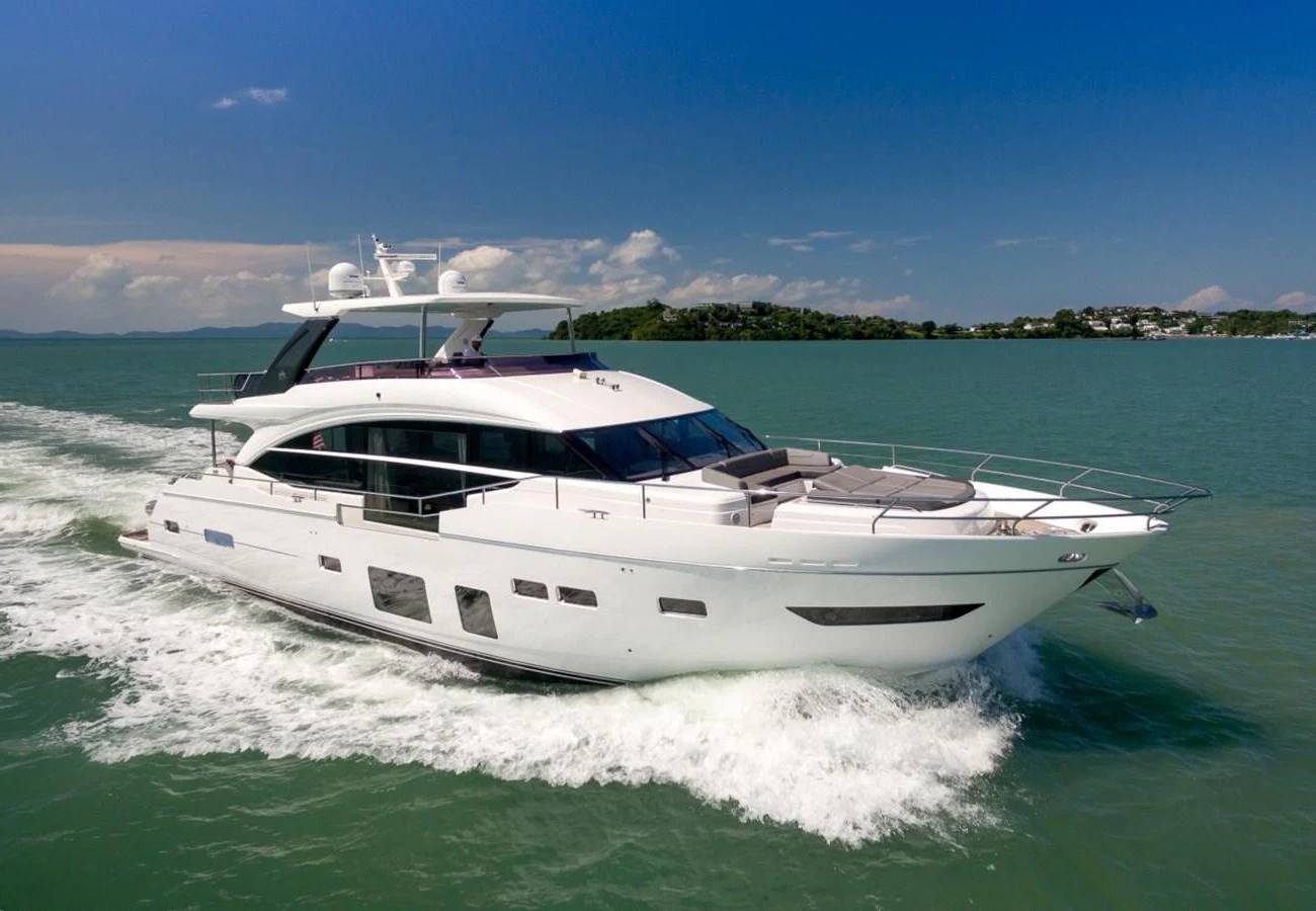 A sleek and modern yacht cruises through calm waters under a clear blue sky. aboard ANDAMAN PRINCESS Yacht for Sale