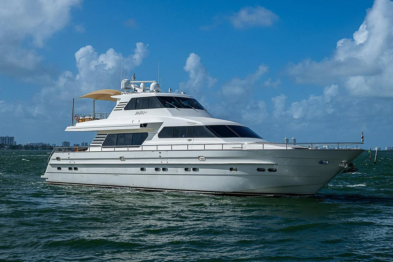 a white yacht in the water aboard THE USUAL Yacht for Sale