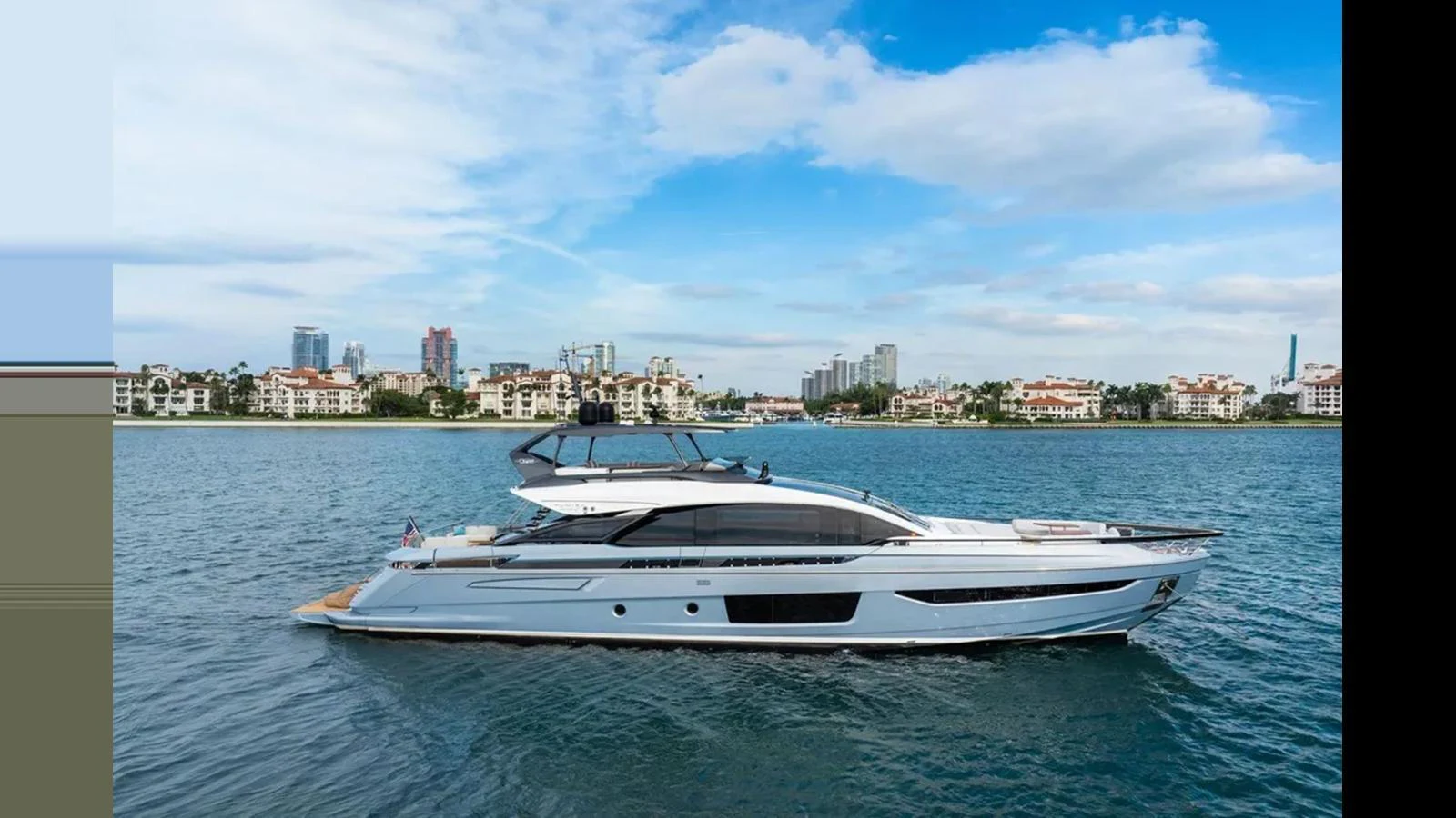 A sleek and modern yacht glides gracefully on calm waters with a cityscape in the background. aboard 2022 AZIMUT S10 Yacht for Sale