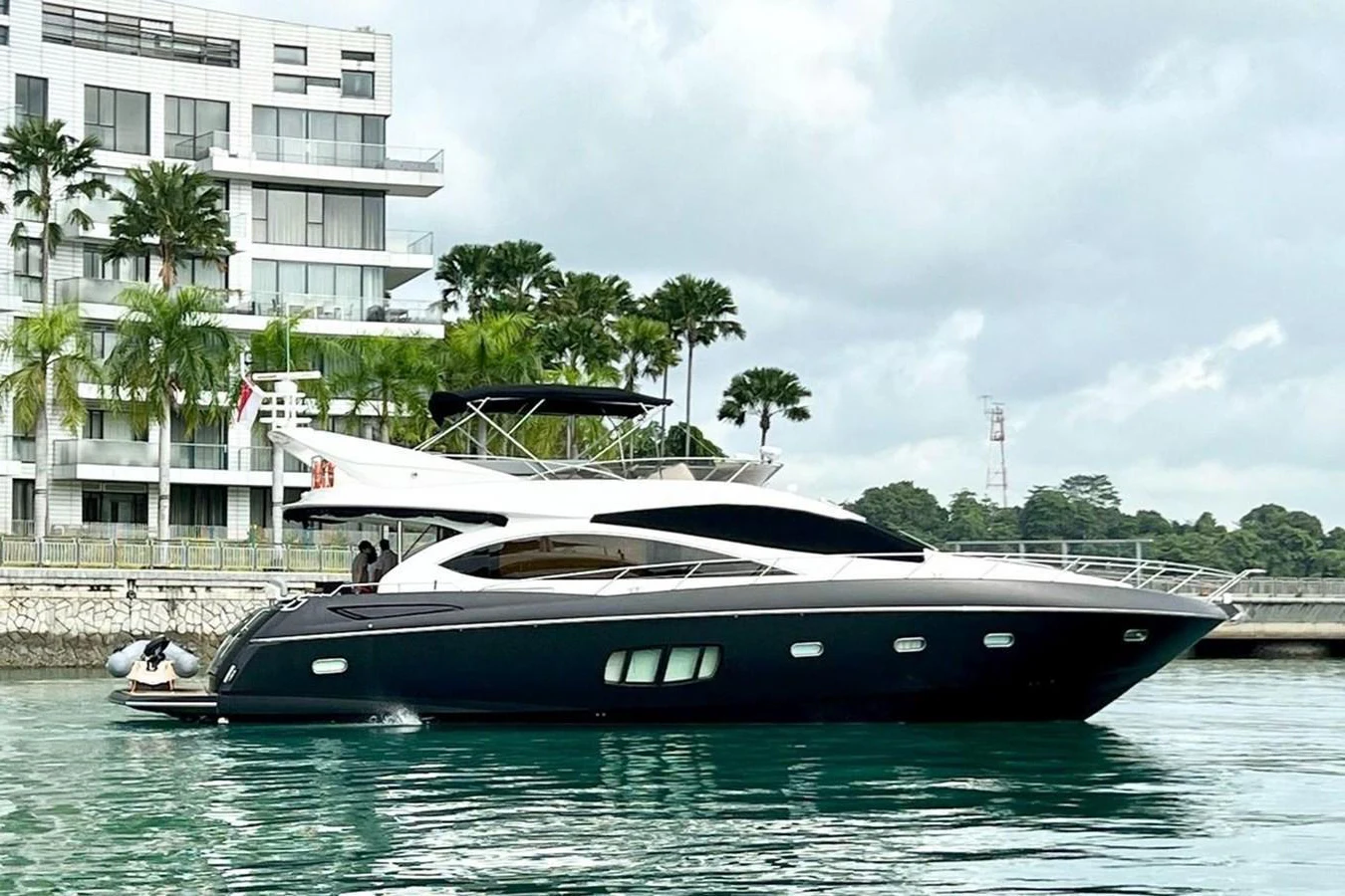 A sleek and modern yacht is docked near a luxurious waterfront property. aboard ELLYN Yacht for Sale