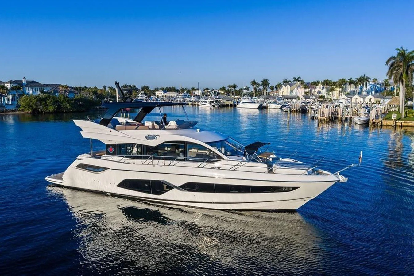 A sleek and modern yacht glides gracefully on calm waters in a picturesque marina setting. aboard ELLIGANCE Yacht for Sale