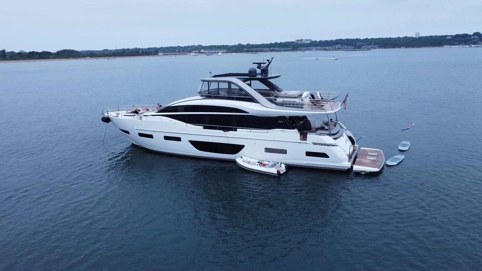 A sleek and modern yacht anchored in calm waters, showcasing its elegant design and spacious decks. aboard KAOS Yacht for Sale