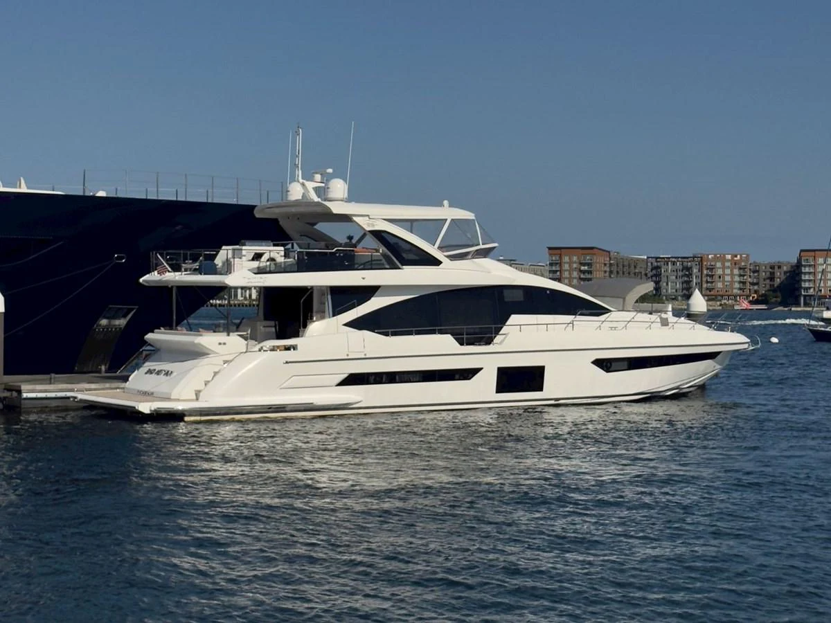 A sleek and modern yacht is docked in a marina, showcasing its elegant lines and spacious decks. aboard 2022 AZIMUT GRANDE 25M Yacht for Sale
