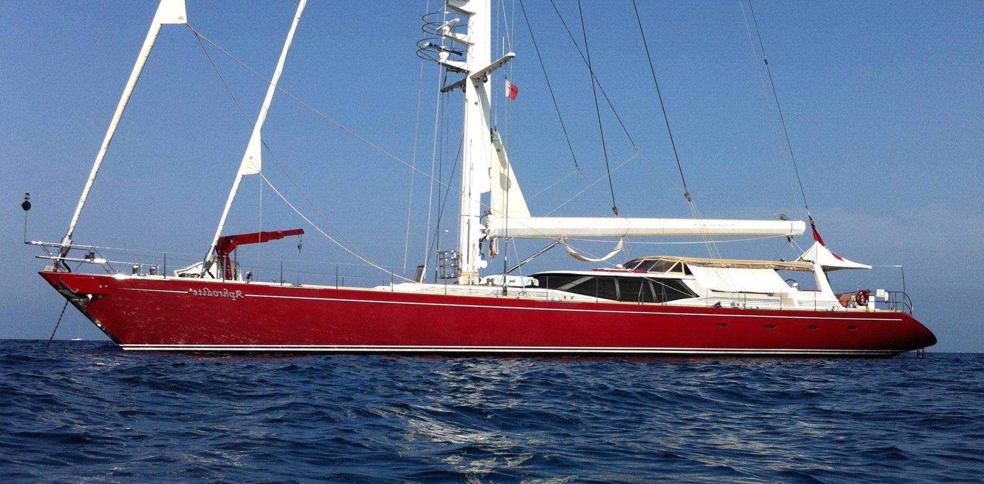 a red and white boat on the water aboard APHRODITE A Yacht for Sale