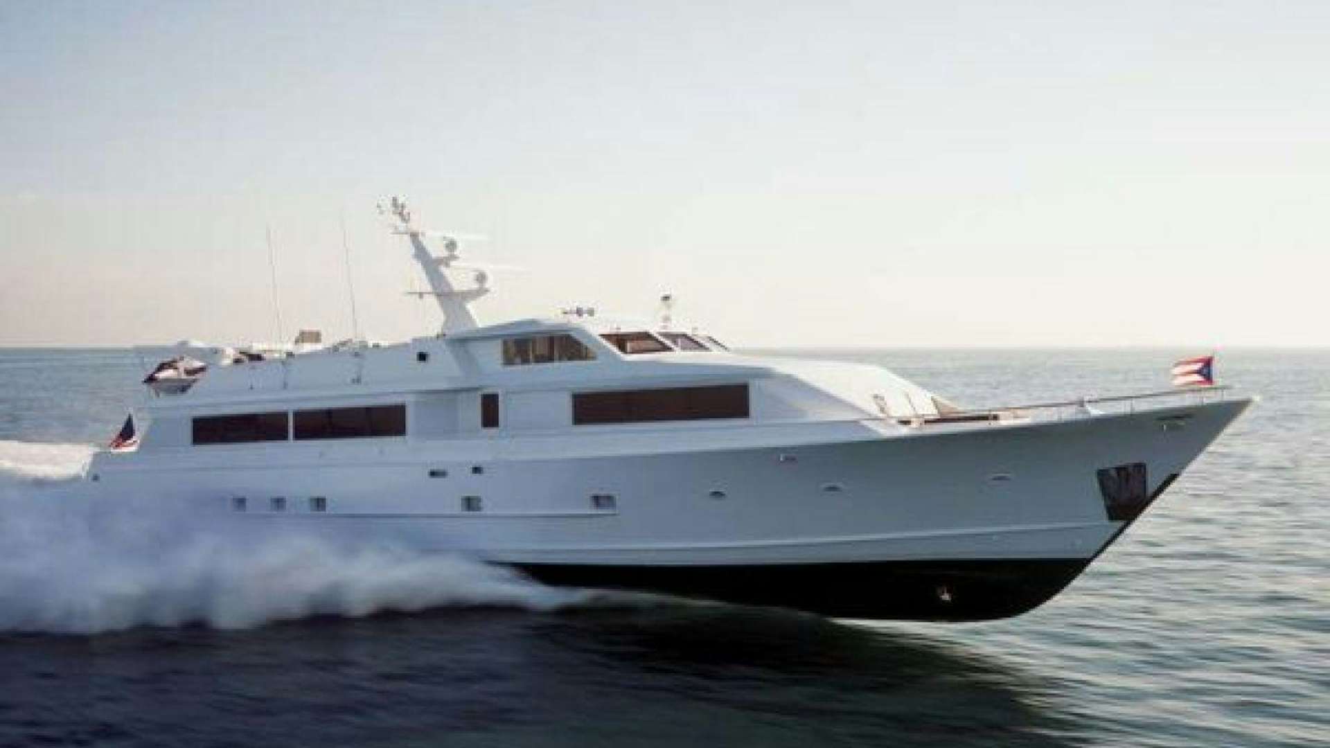 a white yacht in the water aboard THUNDERBALL Yacht for Sale