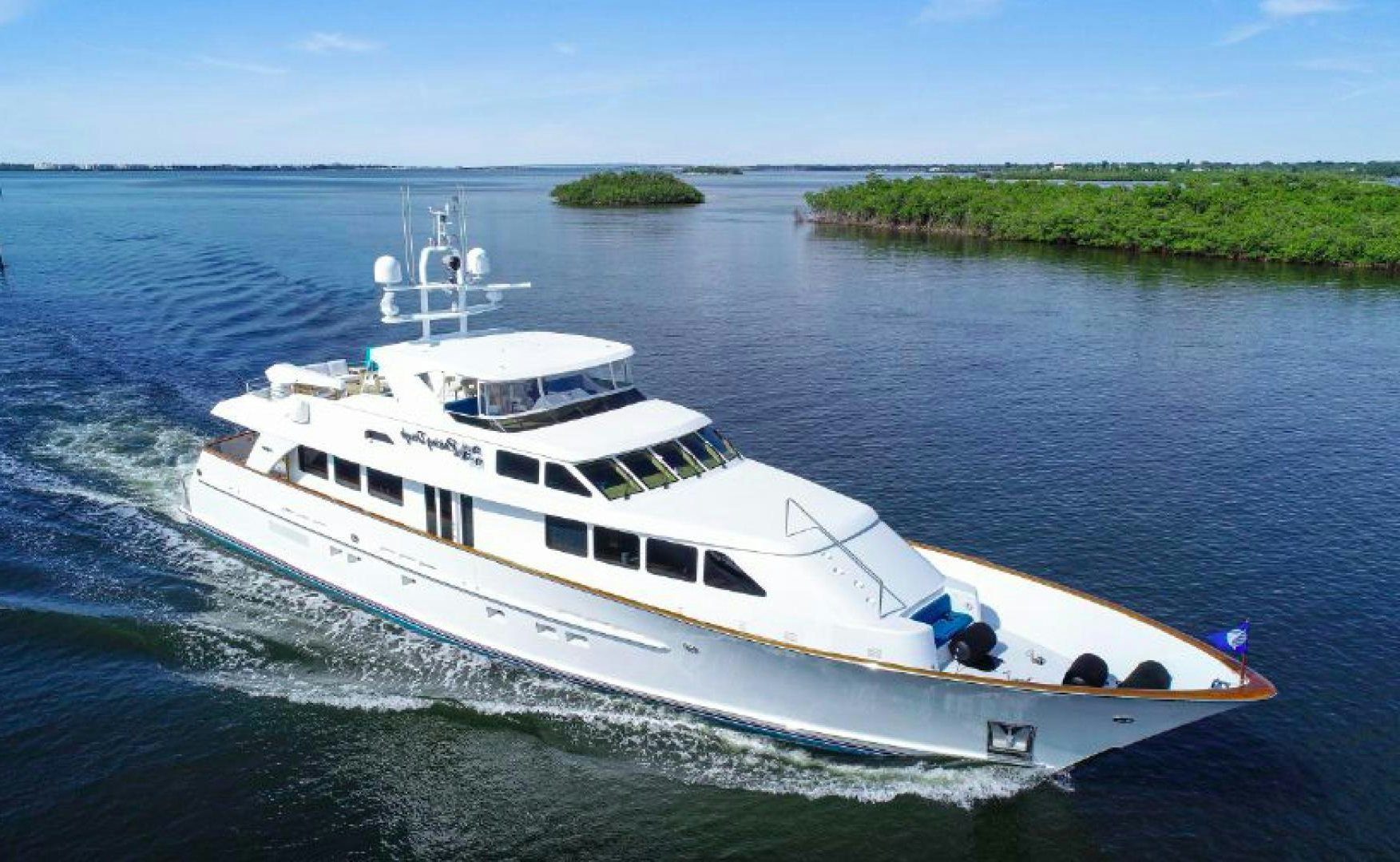 a white yacht on the water aboard RAISING DOUGH Yacht for Sale