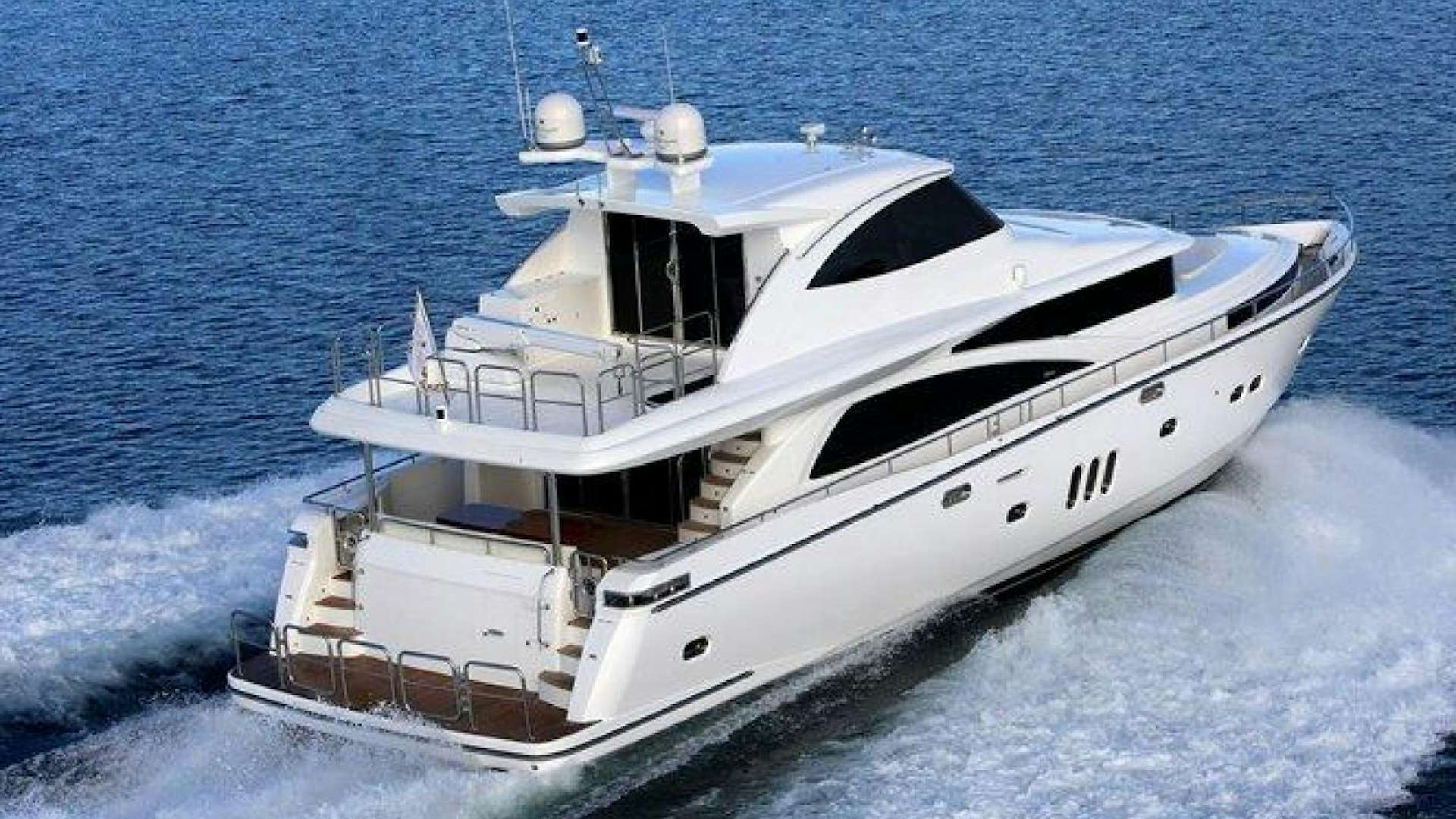 a white yacht in the water aboard JOHNSON 83 SKYLOUNGE Yacht for Sale