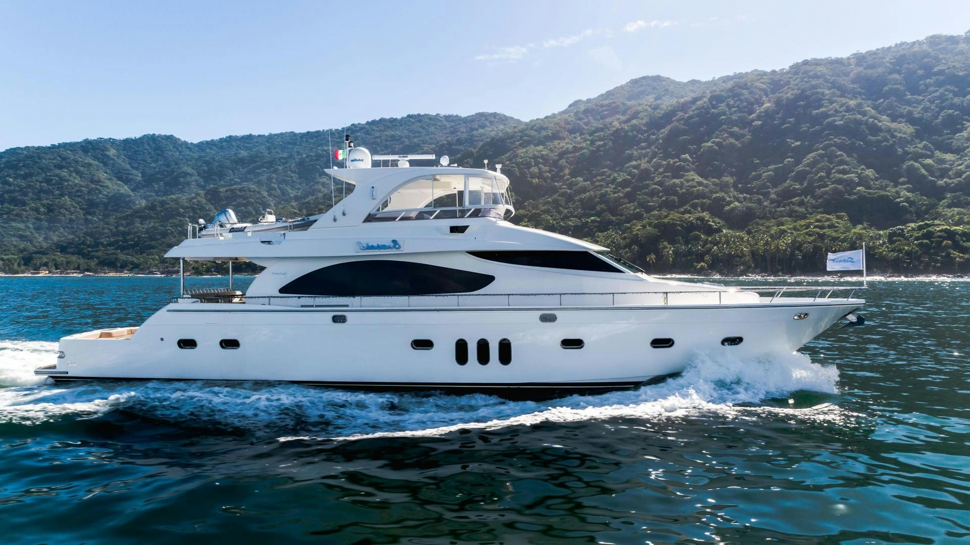 a white yacht on the water aboard FULL HOUSE Yacht for Sale
