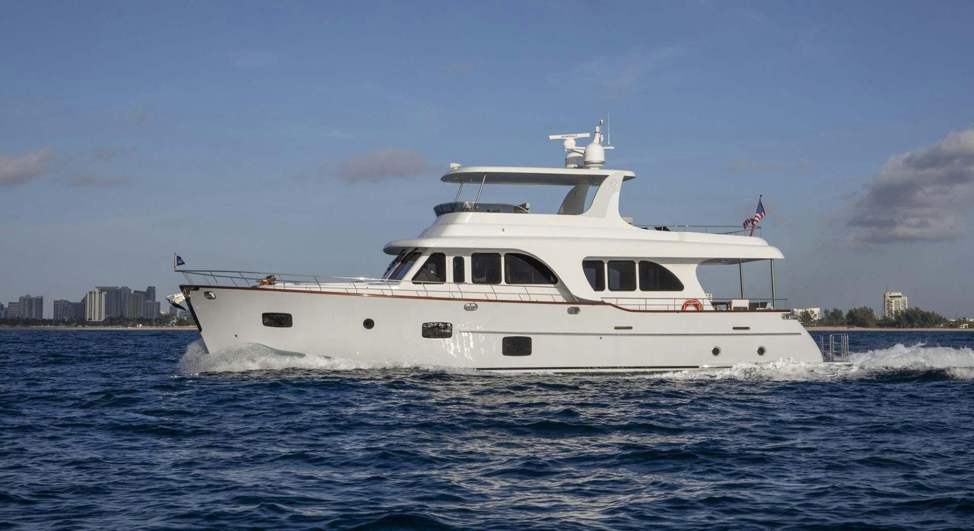 a white boat on the water aboard 67 CRUISER Yacht for Sale