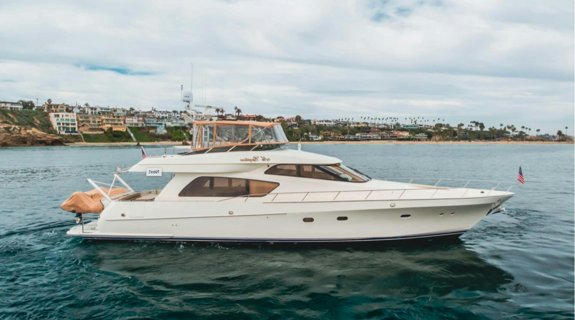a white yacht in the water aboard no exceptions Yacht for Sale