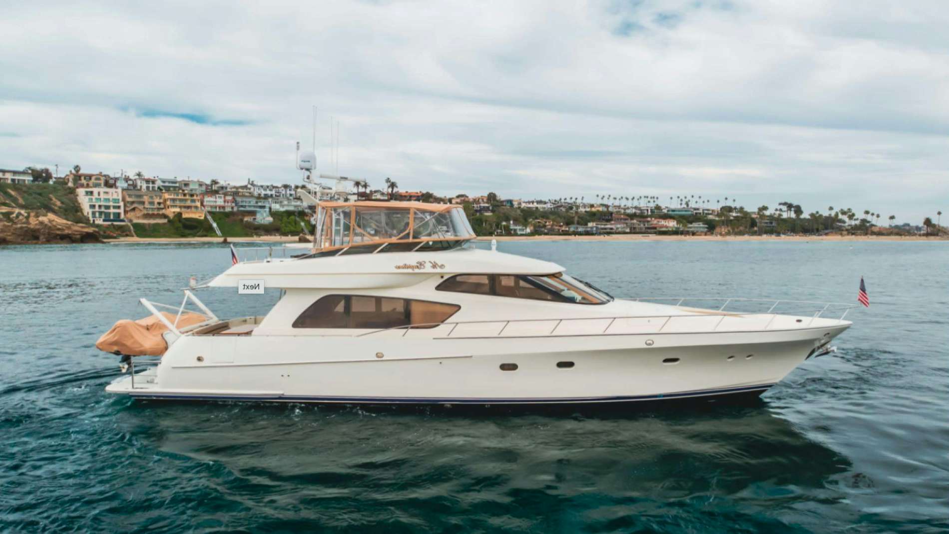 a white yacht in the water aboard no exceptions Yacht for Sale