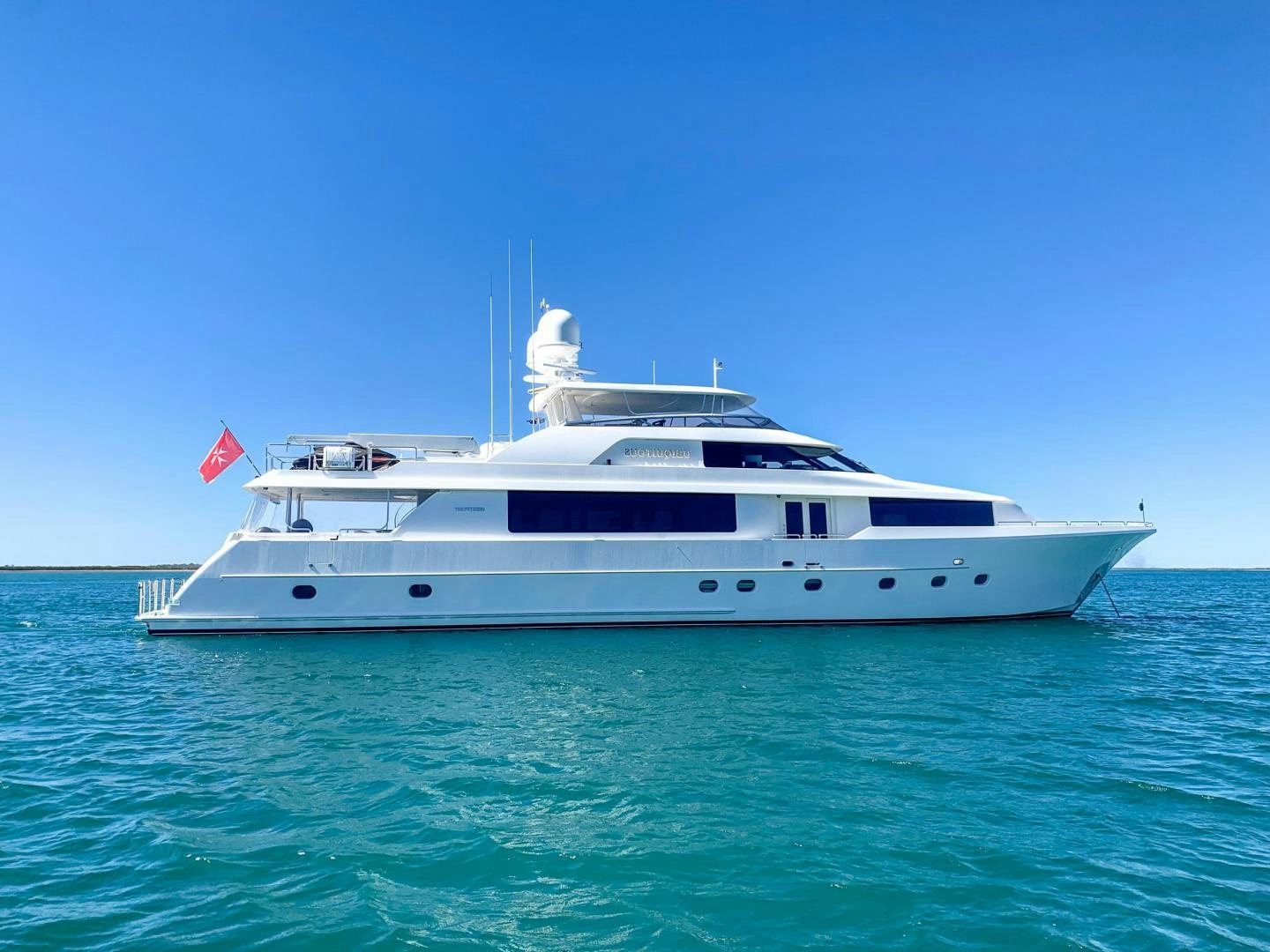 a white yacht in the water aboard SIMPLICITY Yacht for Sale