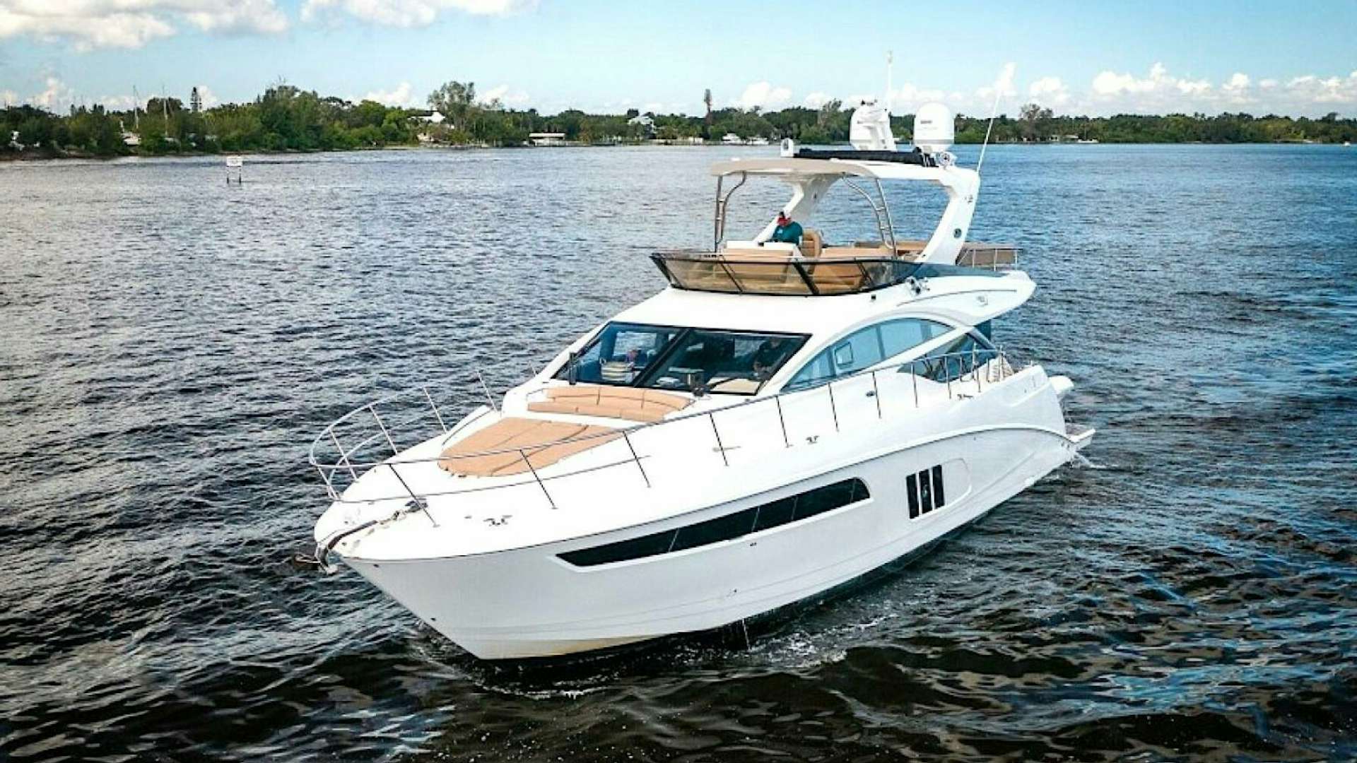 a white boat on the water aboard STELLA BLUE Yacht for Sale