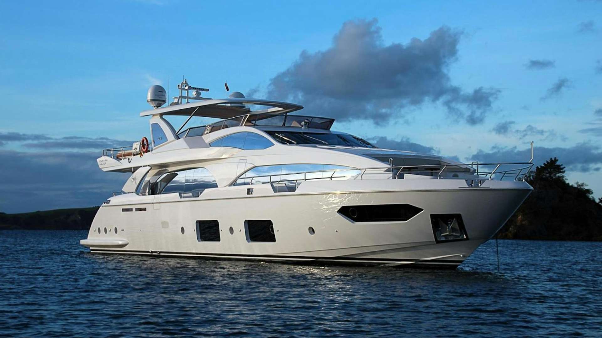 a white yacht on the water aboard LA TACHE Yacht for Sale