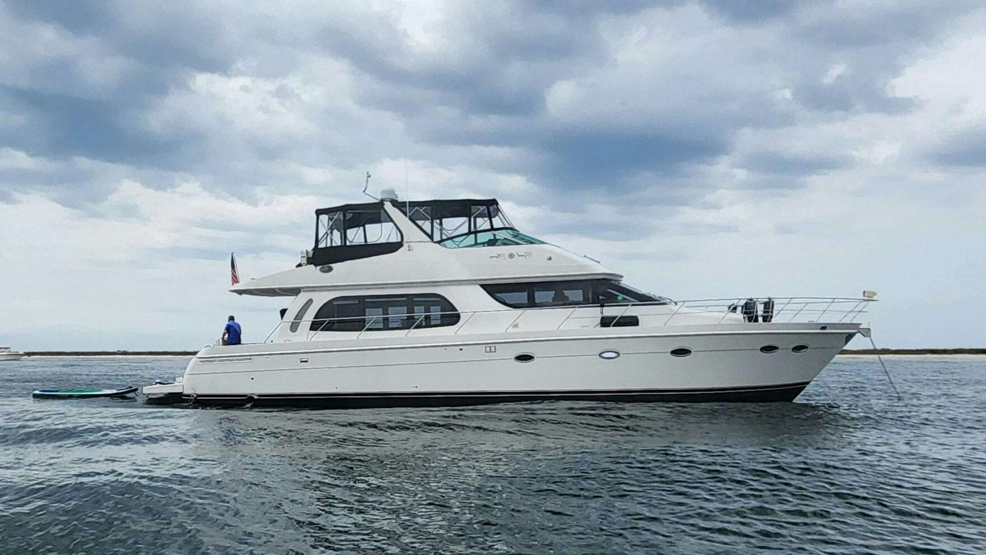a white boat in the water aboard GOOD KARMA Yacht for Sale