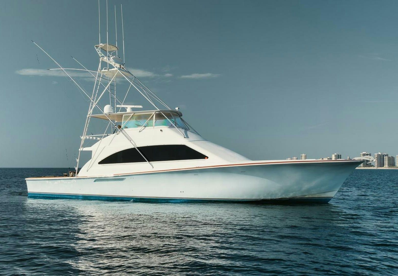 a white boat on the water aboard UNCONQUERED Yacht for Sale