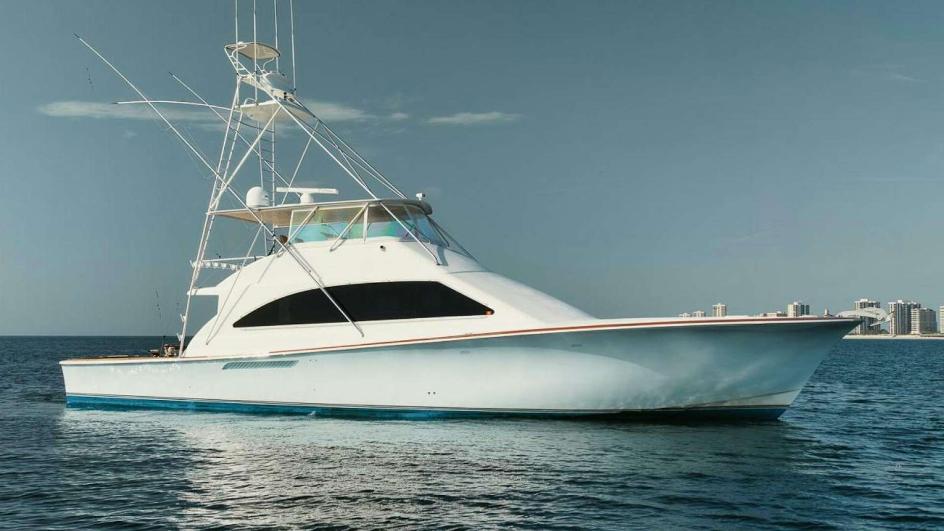 a white boat on the water aboard UNCONQUERED Yacht for Sale