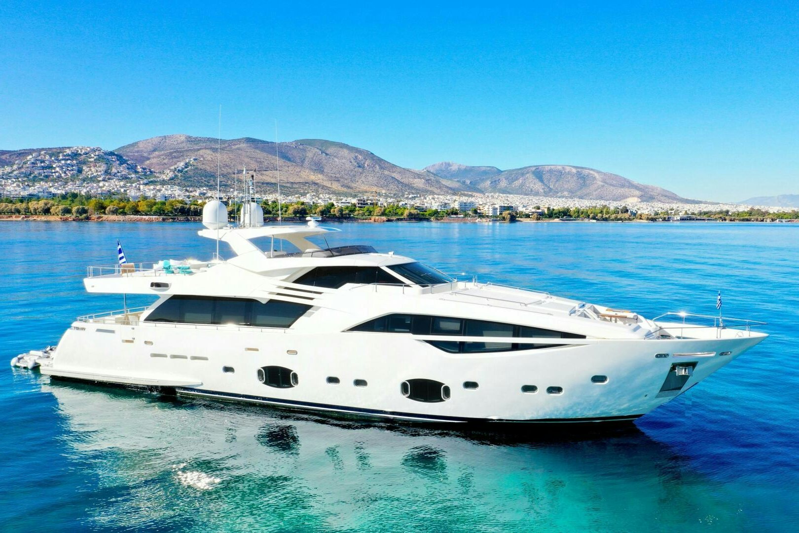 a white yacht in the water aboard INFINITAS Yacht for Sale