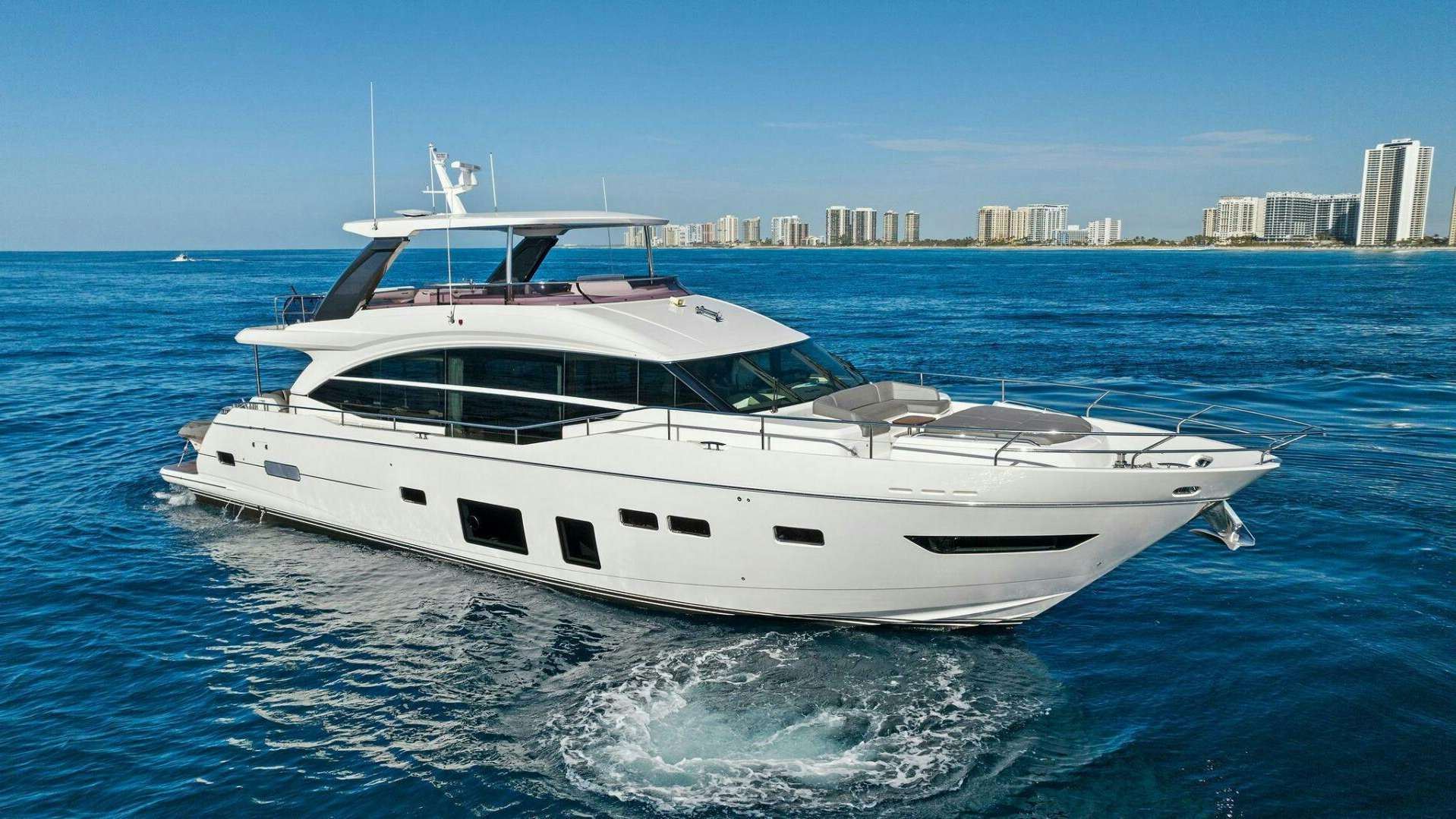 a white yacht on the water aboard AMICI Yacht for Sale