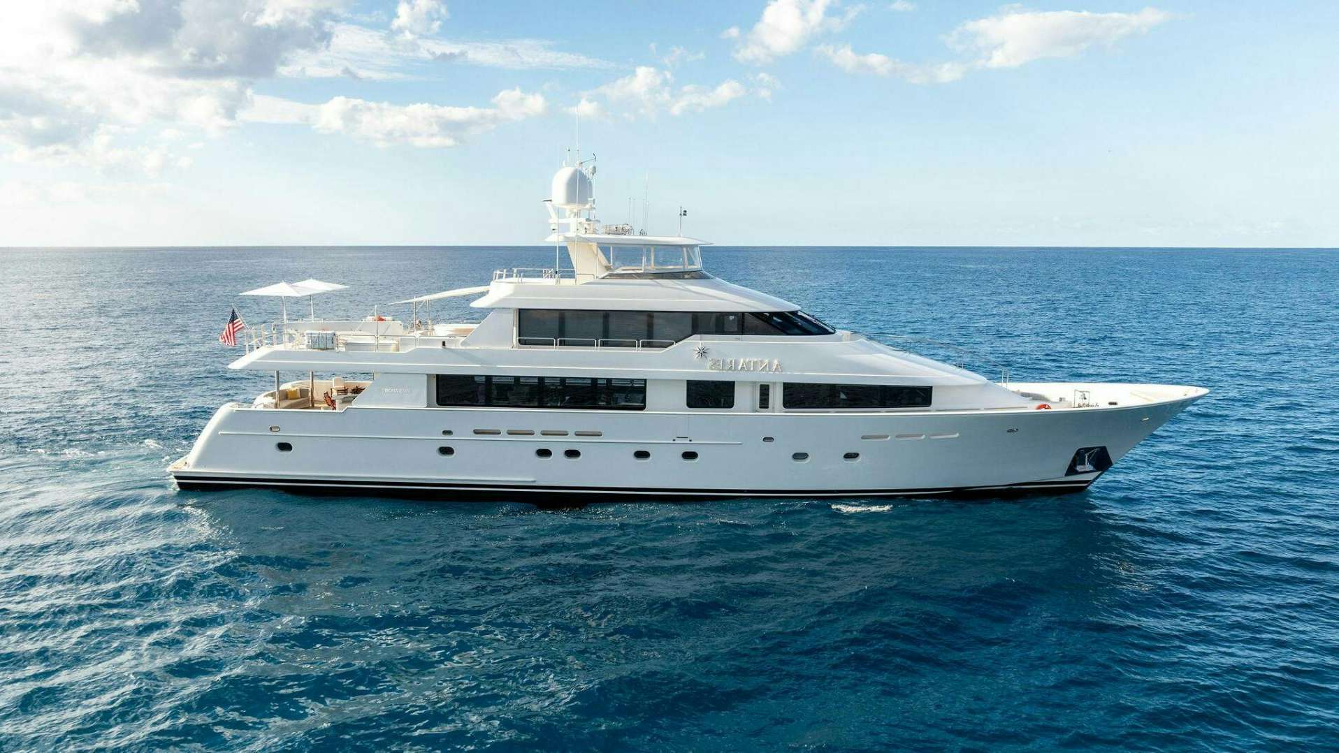 a white yacht in the water aboard ANTARES Yacht for Sale