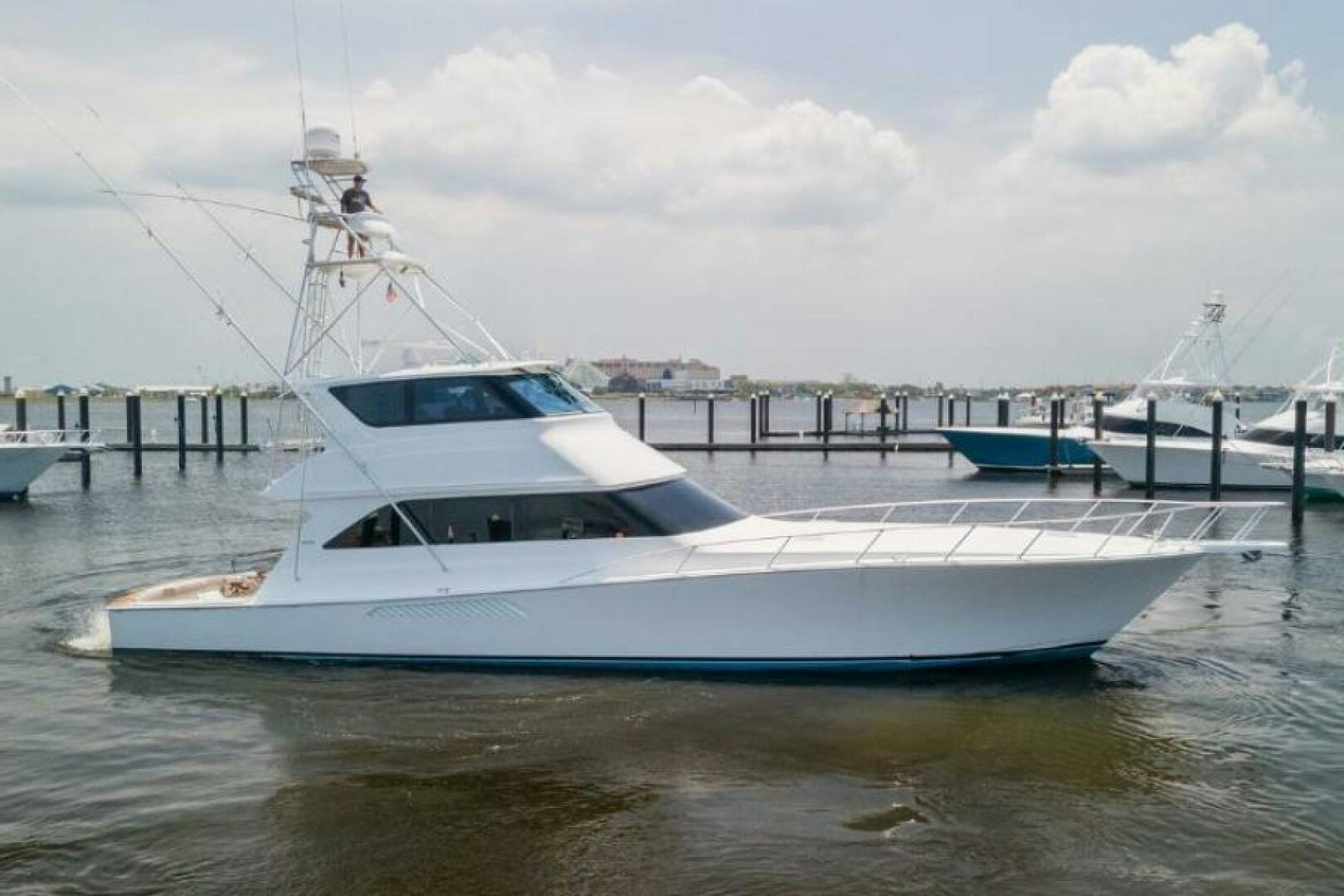 a white yacht docked at a pier aboard SALT STRUK Yacht for Sale