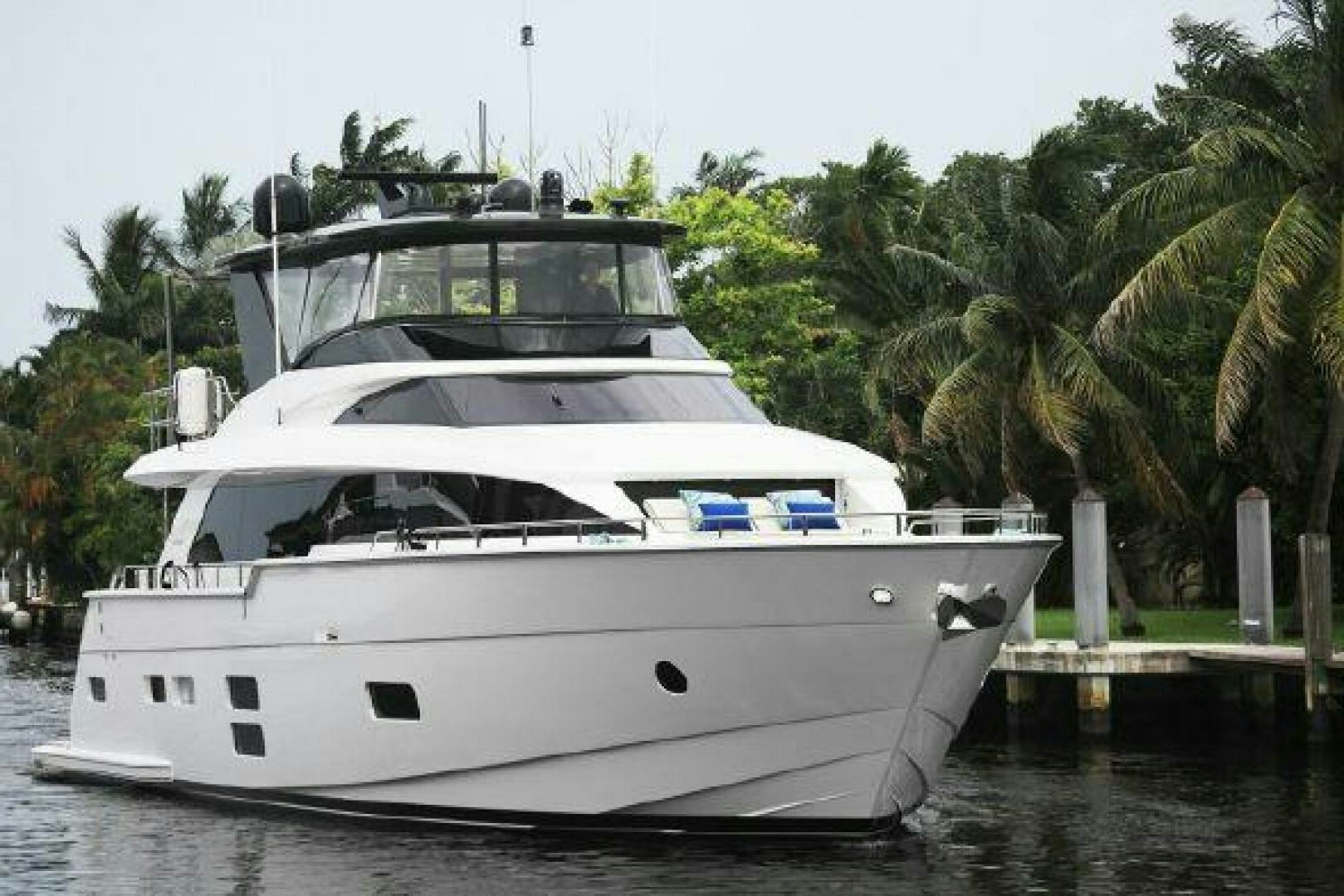 a white yacht in a harbor aboard 75 HATTERAS M75 / 2020 Yacht for Sale