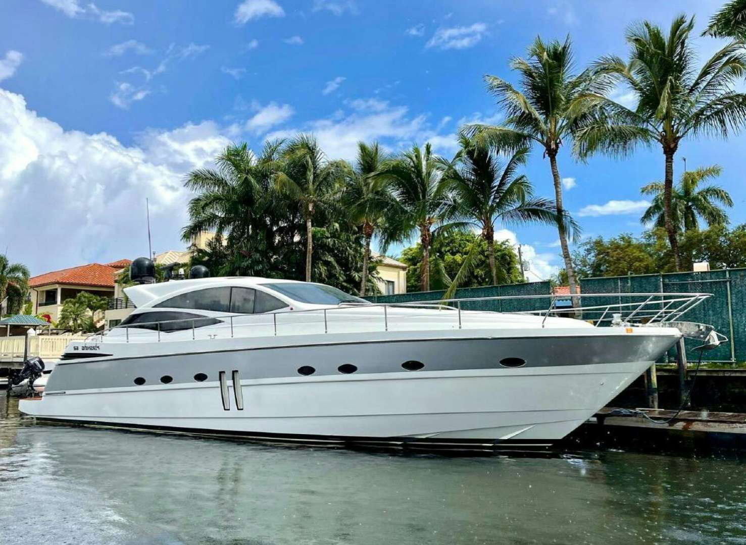 a white yacht docked at a pier aboard PERSHING 90 Yacht for Sale