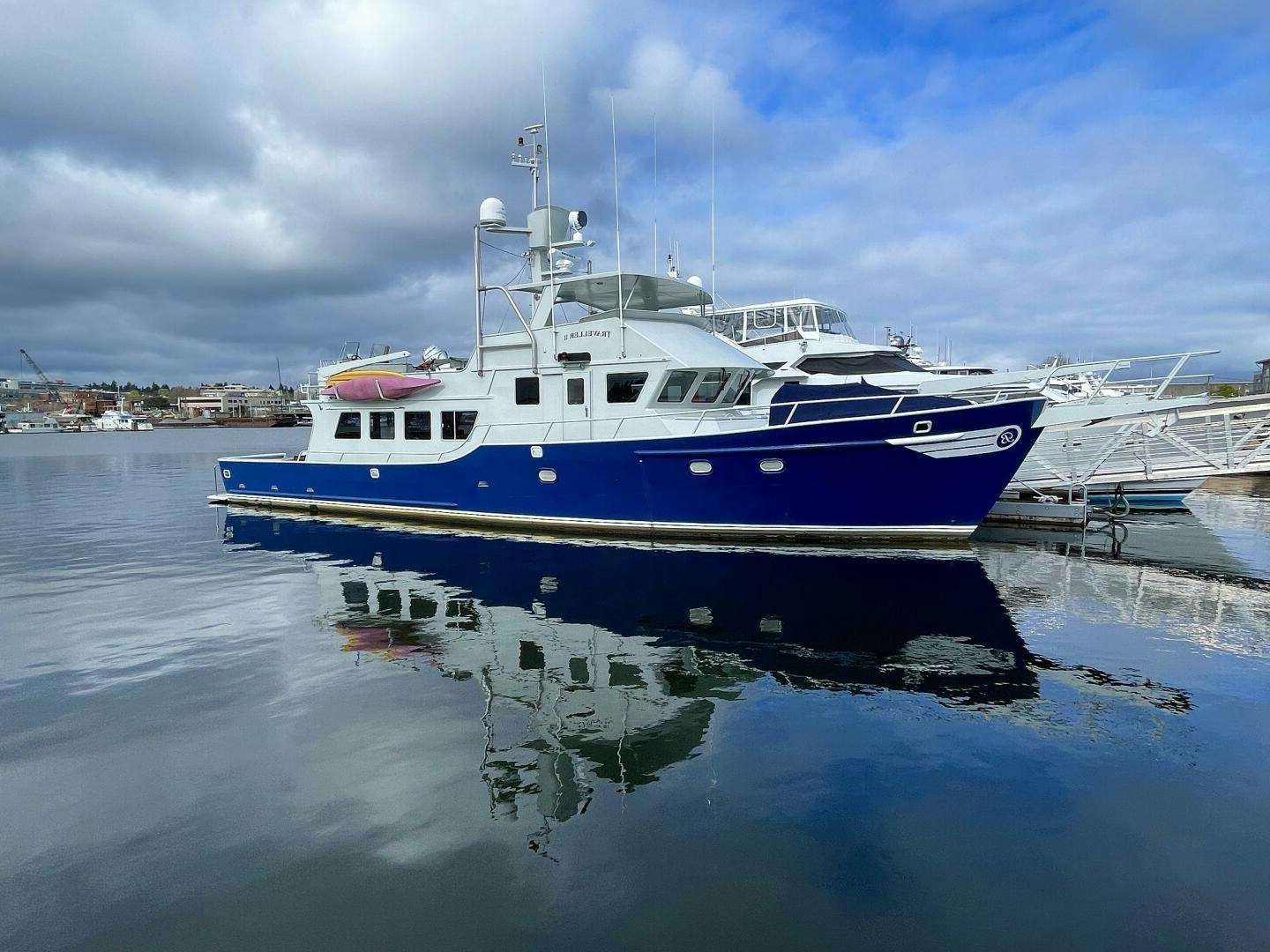a large white boat in the water aboard TRAVELLER II Yacht for Sale