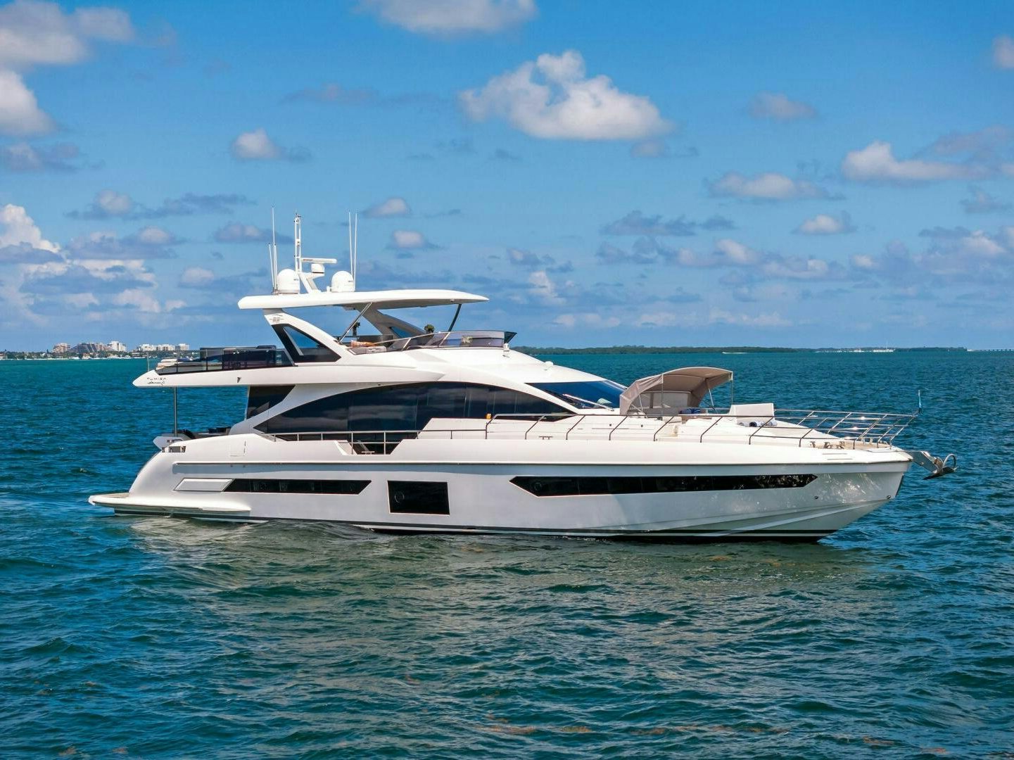 a white yacht in the water aboard LIMITLESS Yacht for Sale