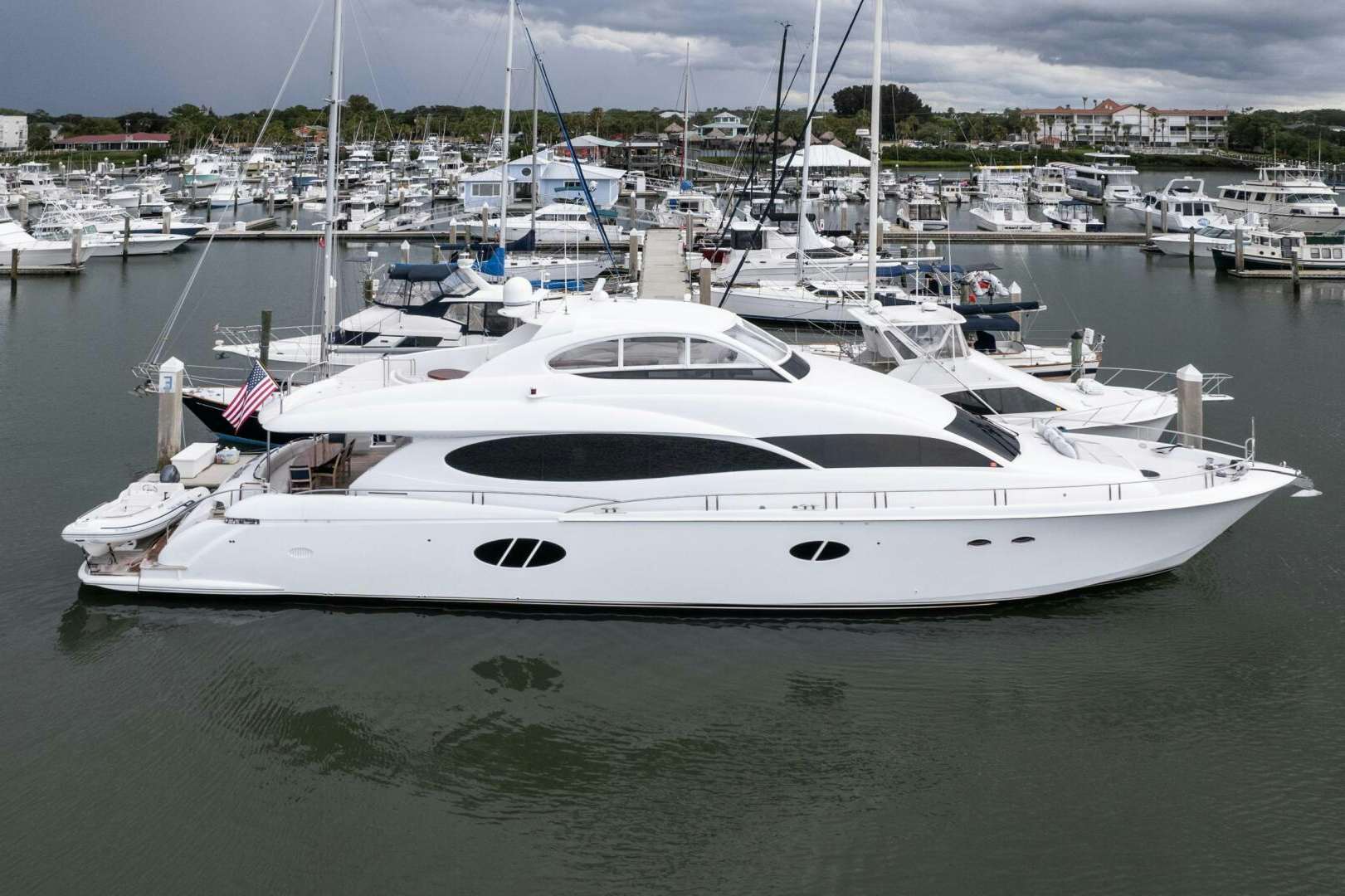 a white yacht in a harbor aboard HIGH LIFE Yacht for Sale