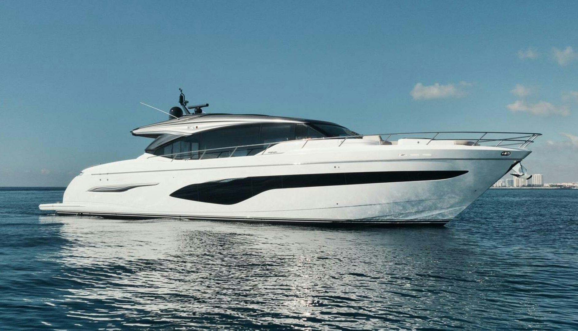 a white yacht on the water aboard HOOKED HER Yacht for Sale