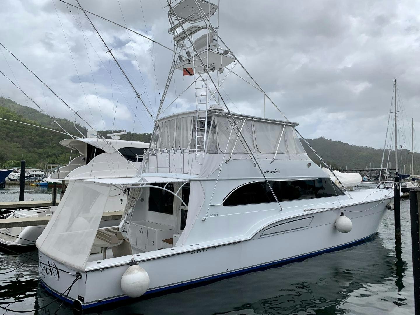 a white boat in a harbor aboard OBSESSION Yacht for Sale