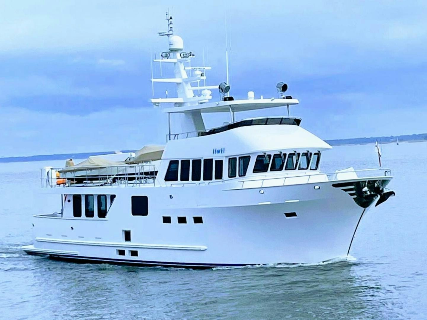 a white boat in the water aboard IIWII Yacht for Sale