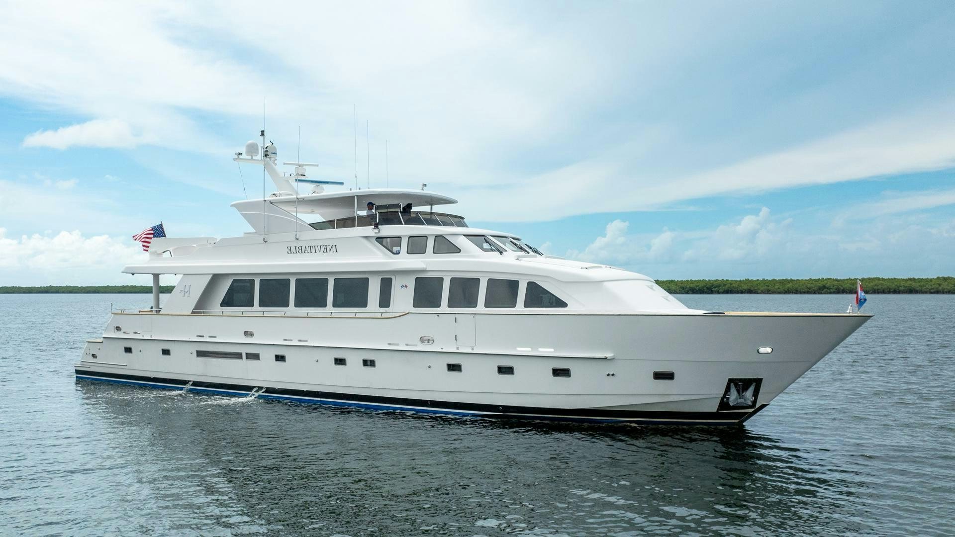 a white yacht in the water aboard INEVITABLE Yacht for Sale