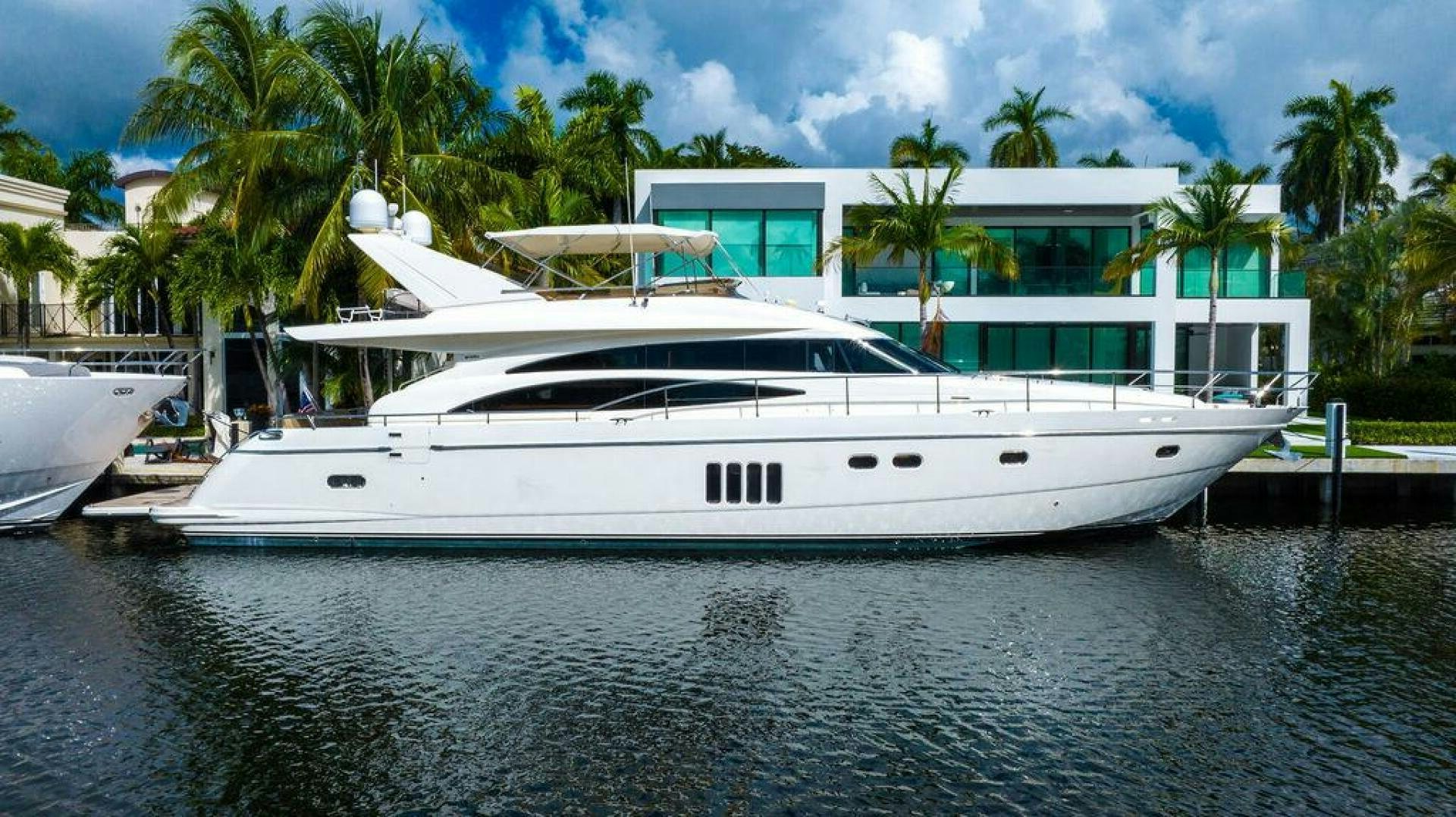 a white yacht docked at a dock aboard EMPIRE SUN Yacht for Sale