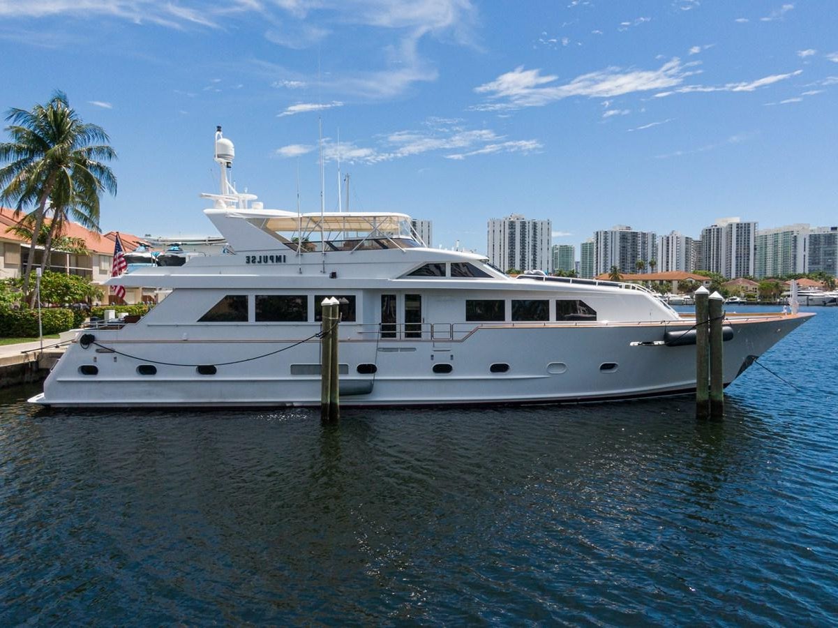 a white boat in the water aboard IMPULSE Yacht for Sale