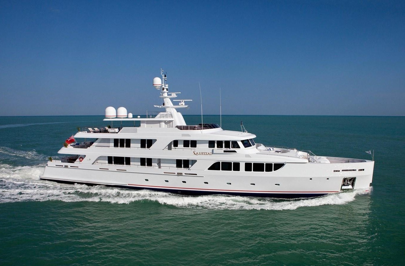 a large white boat in the ocean aboard KADIMO'S Yacht for Sale