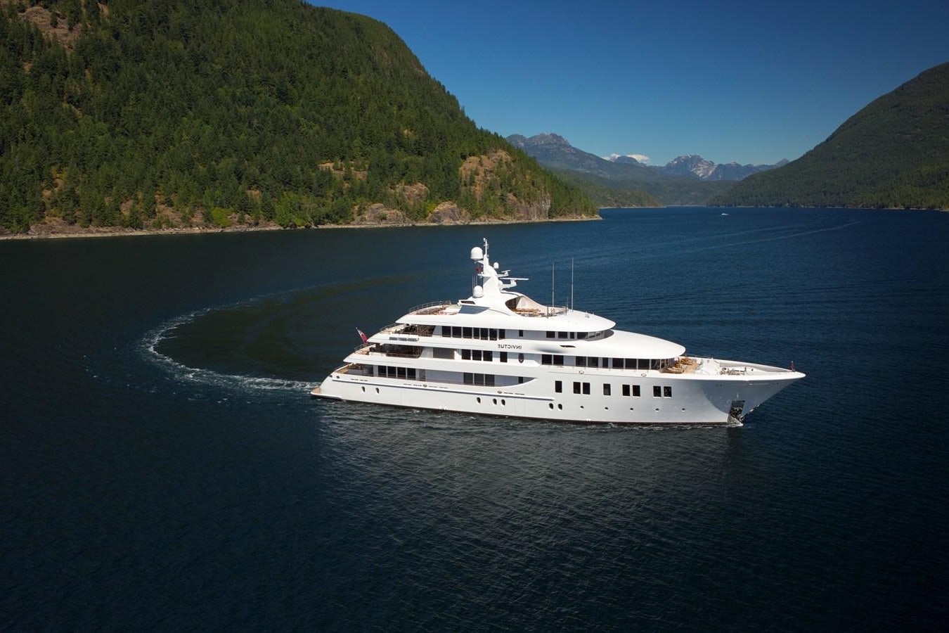 a white boat on water aboard INVICTUS Yacht for Sale