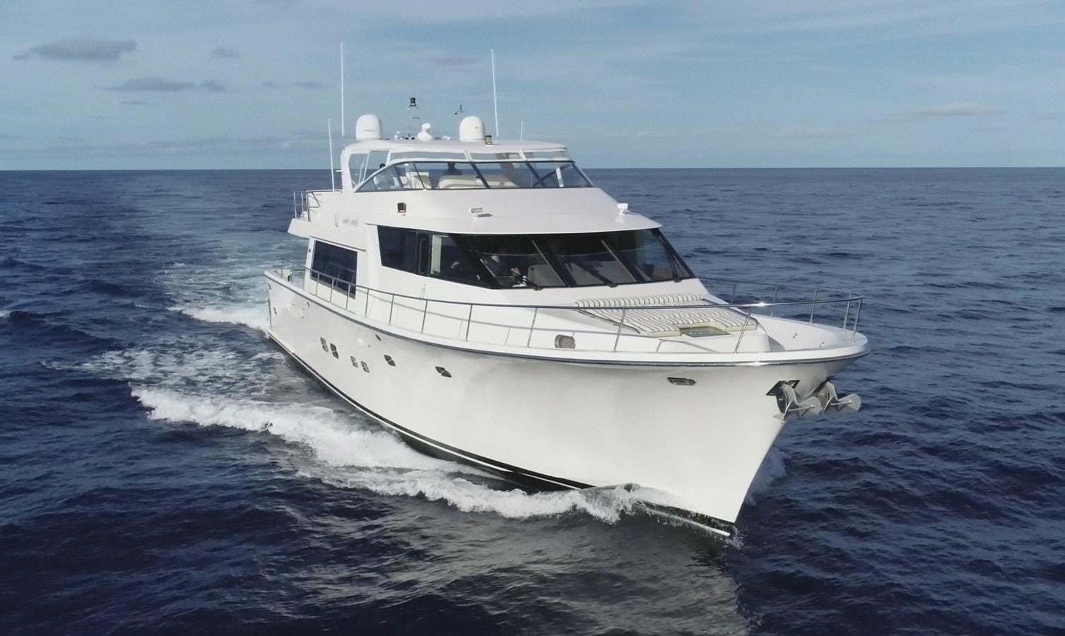 a white boat on the water aboard LUCKY AGAIN Yacht for Sale