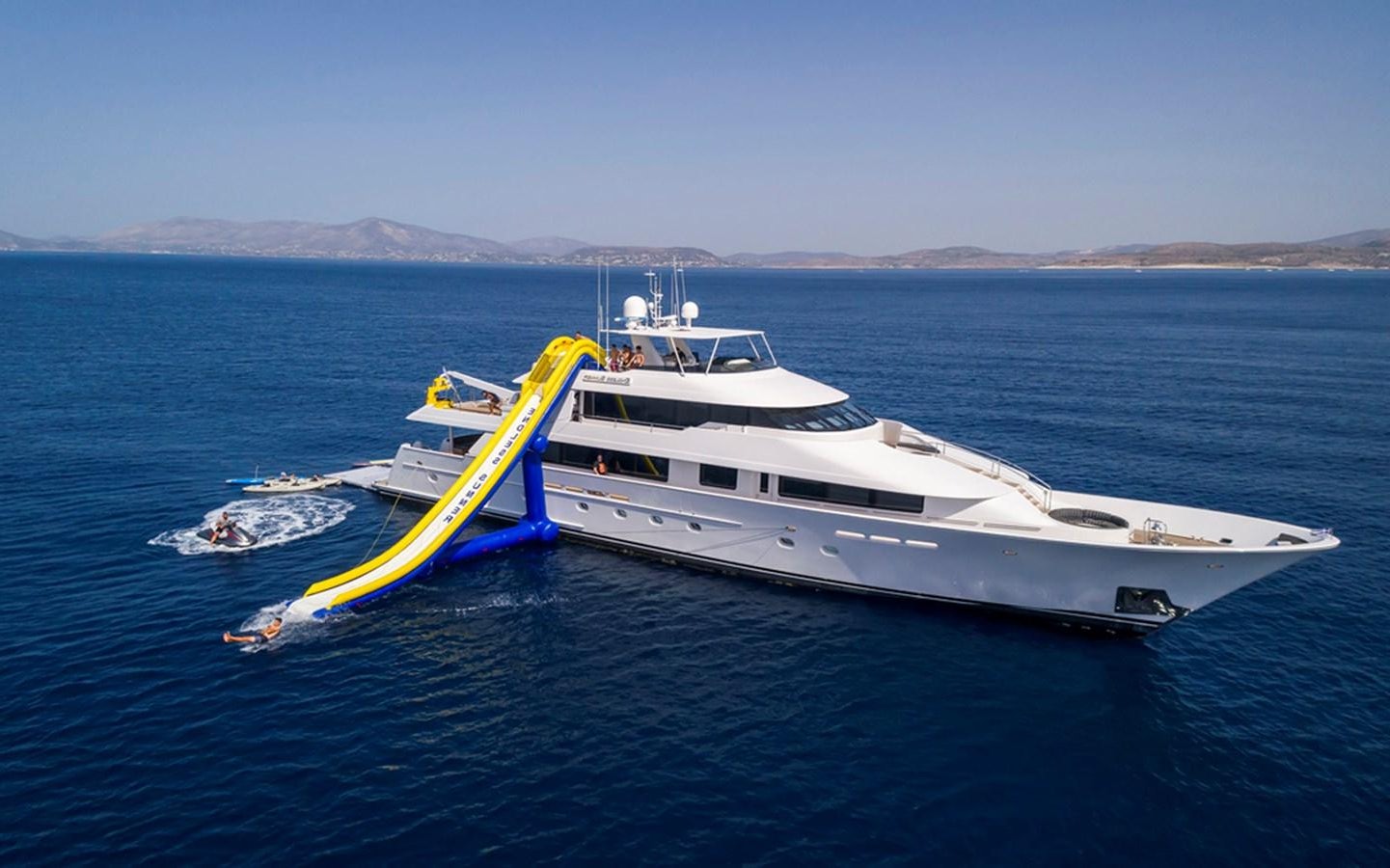 a boat with a yellow sail on the water aboard ENDLESS SUMMER Yacht for Sale