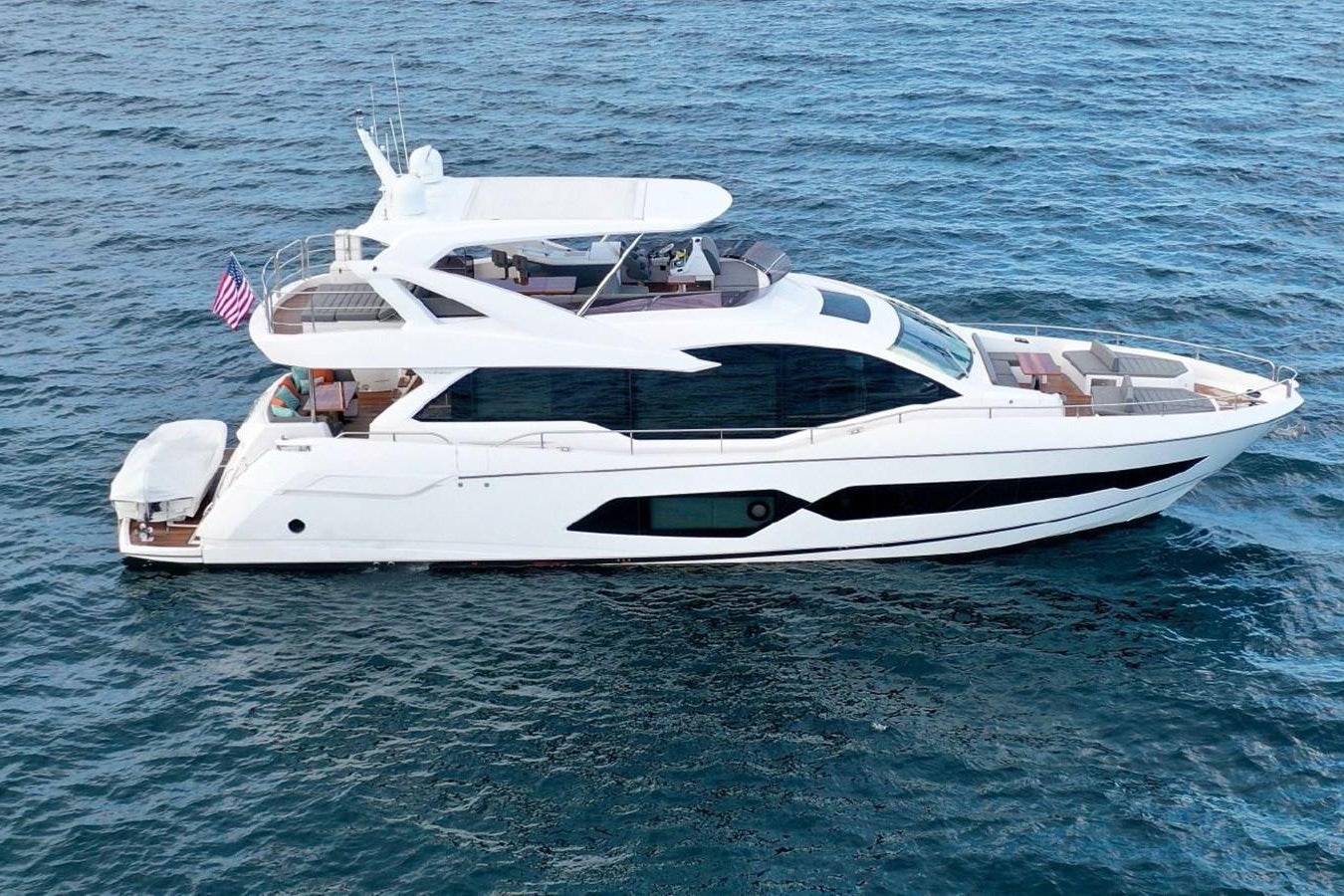 a white yacht on the water aboard DO  ANYWAY Yacht for Sale