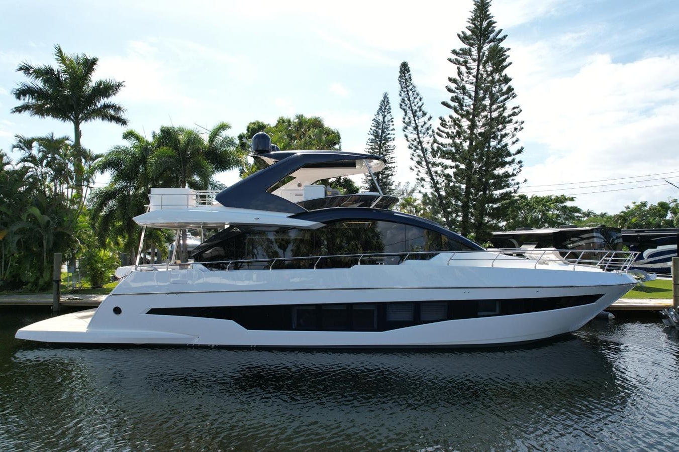 a white yacht in a harbor aboard 2024 ASTONDOA 66 FLYBRIDGE Yacht for Sale