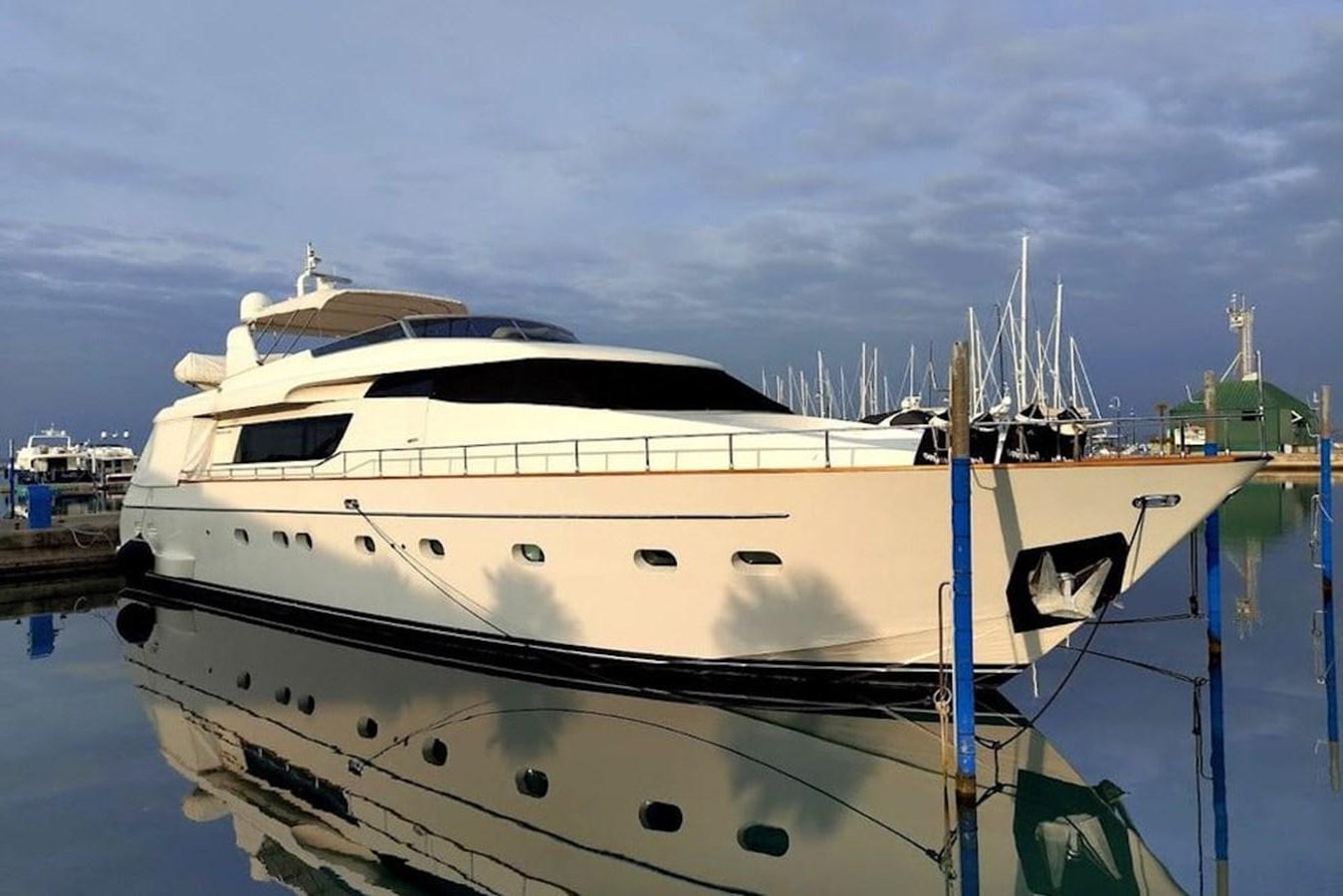 a white yacht in a harbor aboard SL 82 Yacht for Sale