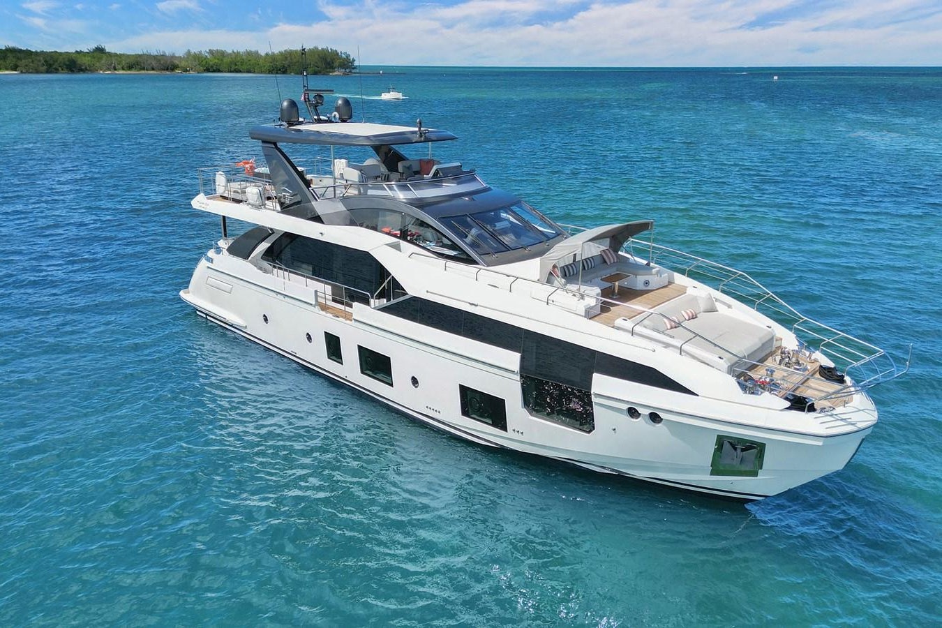 a white yacht in the water aboard ENCHANTE Yacht for Sale