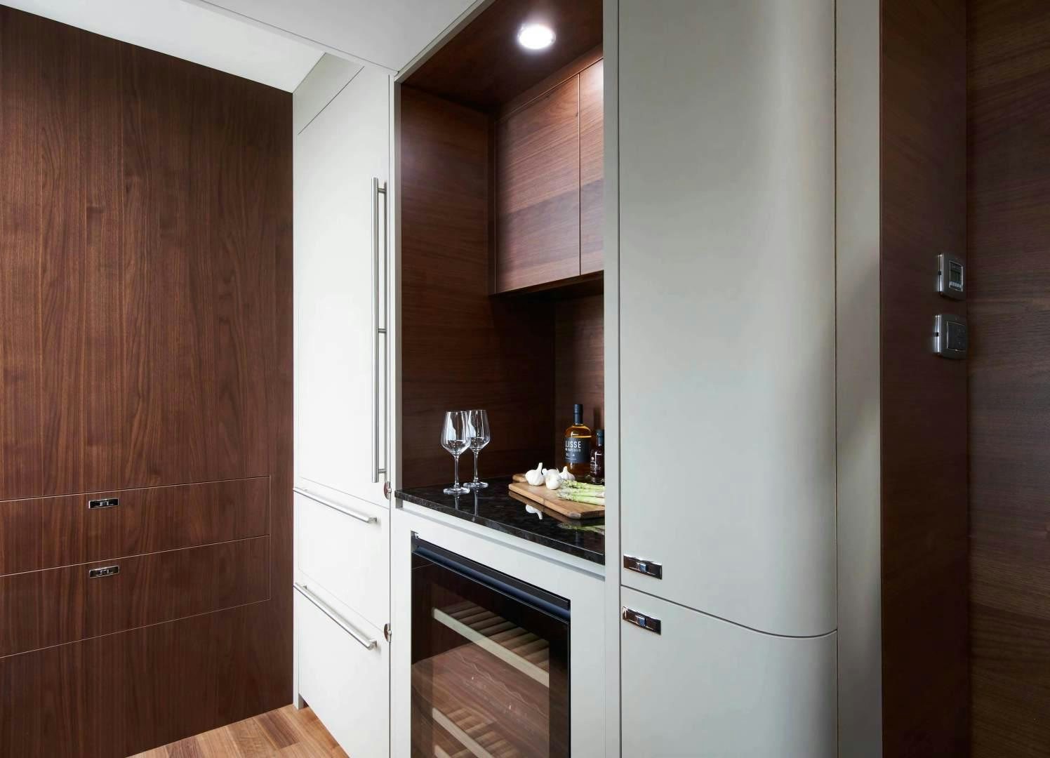 a kitchen with wooden cabinets aboard Y85 Yacht for Sale