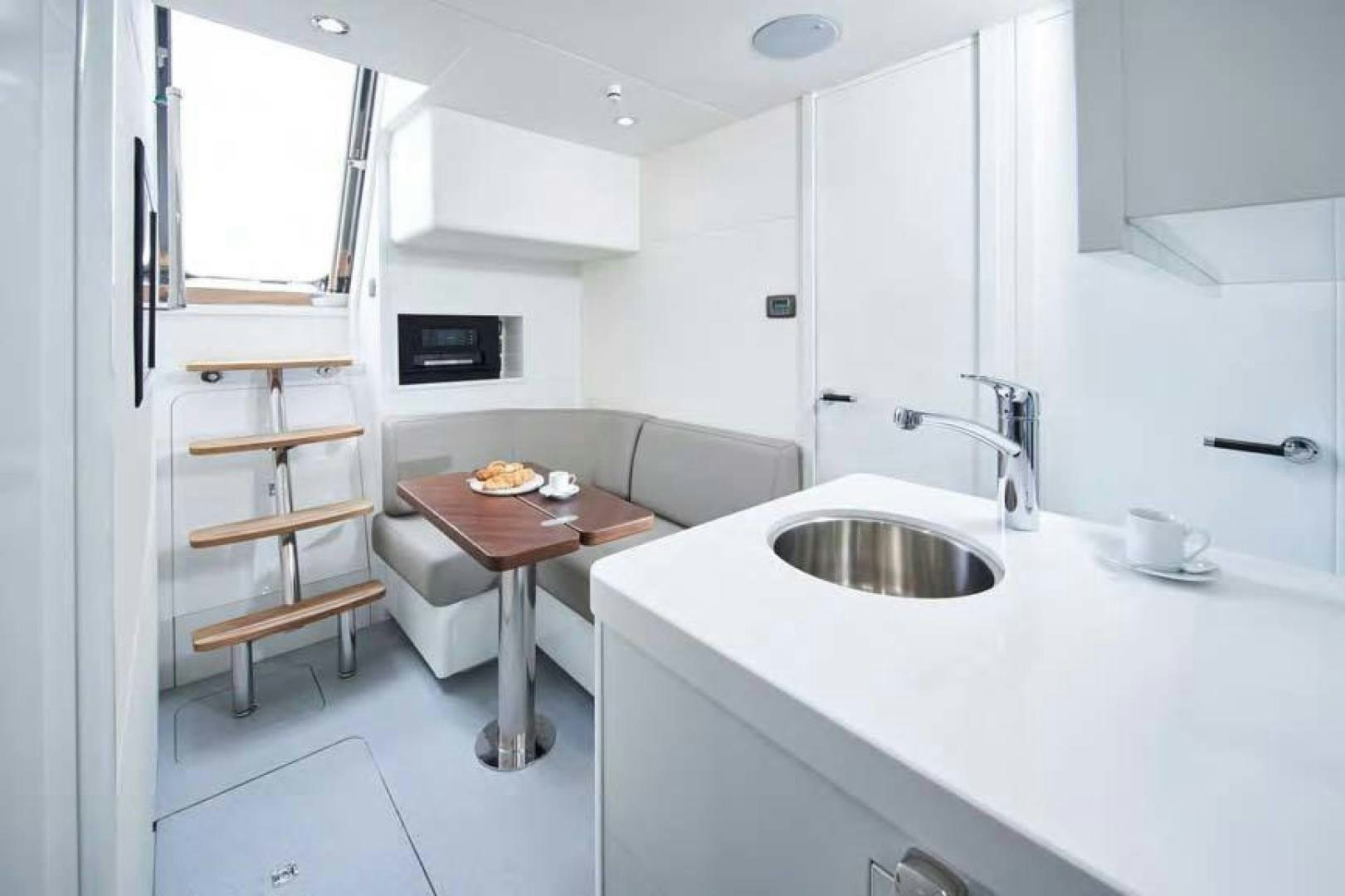a small kitchen with a table aboard Y85 Yacht for Sale