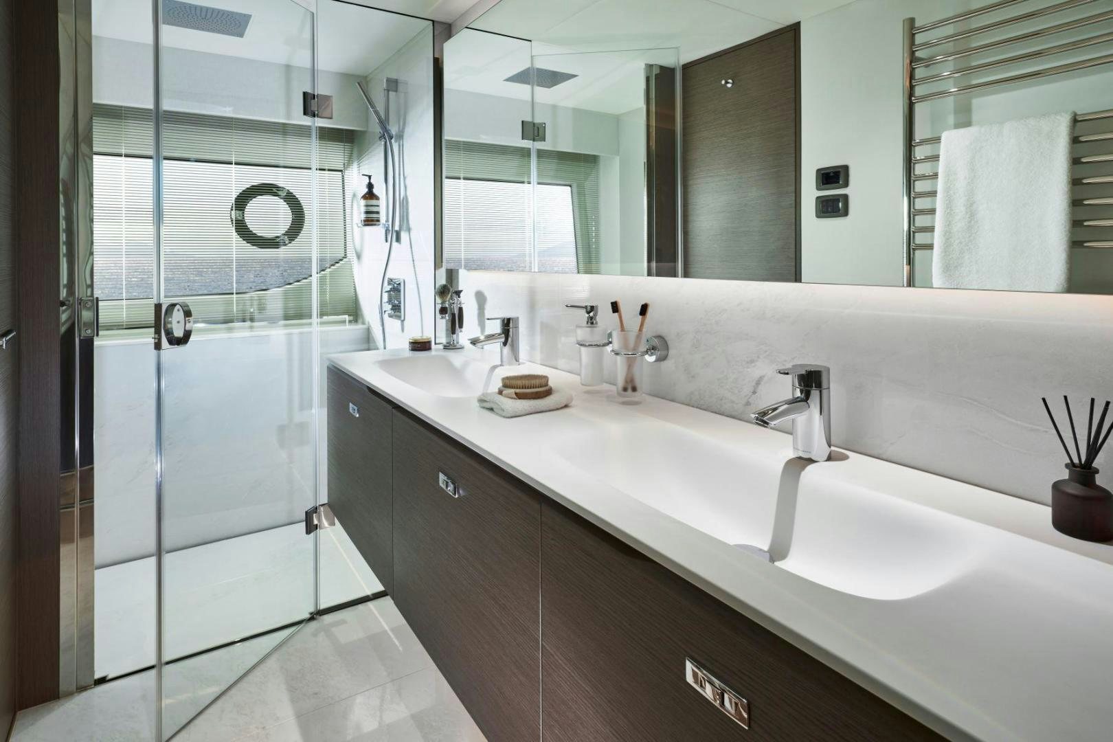 a bathroom with a glass shower aboard Y85 Yacht for Sale
