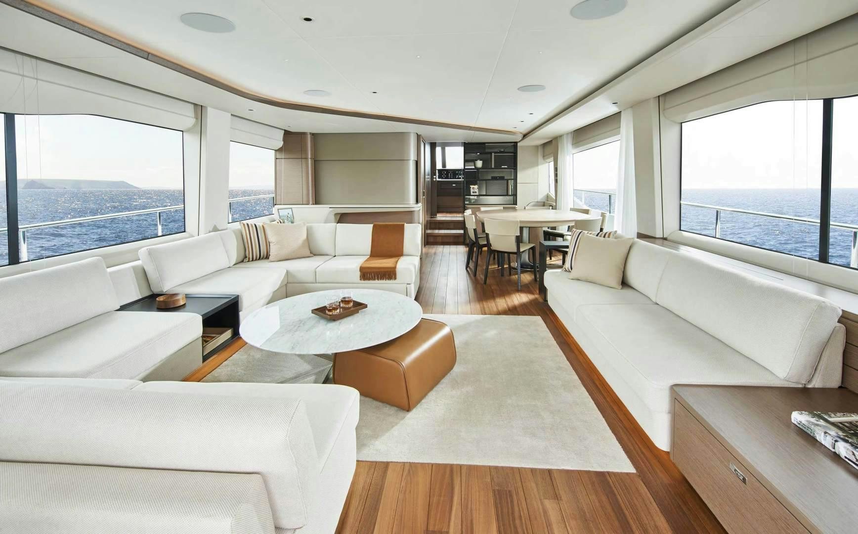 a living room with a couch and a table aboard Y85 Yacht for Sale