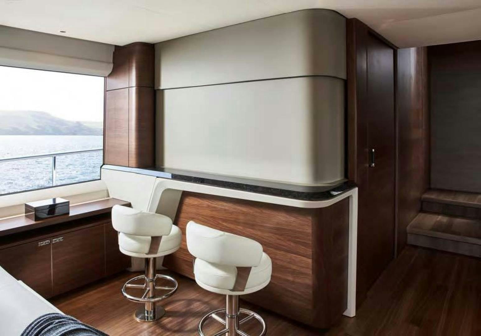 a room with a table and chairs aboard Y85 Yacht for Sale